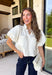 Every wardrobe needs a timeless white denim top, and this one is sure to become a favorite. Crafted from crisp 100% cotton, this classic piece features beautiful tan contrast stitching that adds warmth and dimension to the clean white denim. Feminine puff sleeves give this everyday staple a stylish update, while the collared neckline and front pockets keep the look polished and versatile. You'll find yourself reaching for this top constantly!