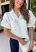 Every wardrobe needs a timeless white denim top, and this one is sure to become a favorite. Crafted from crisp 100% cotton, this classic piece features beautiful tan contrast stitching that adds warmth and dimension to the clean white denim. Feminine puff sleeves give this everyday staple a stylish update, while the collared neckline and front pockets keep the look polished and versatile. You'll find yourself reaching for this top constantly!