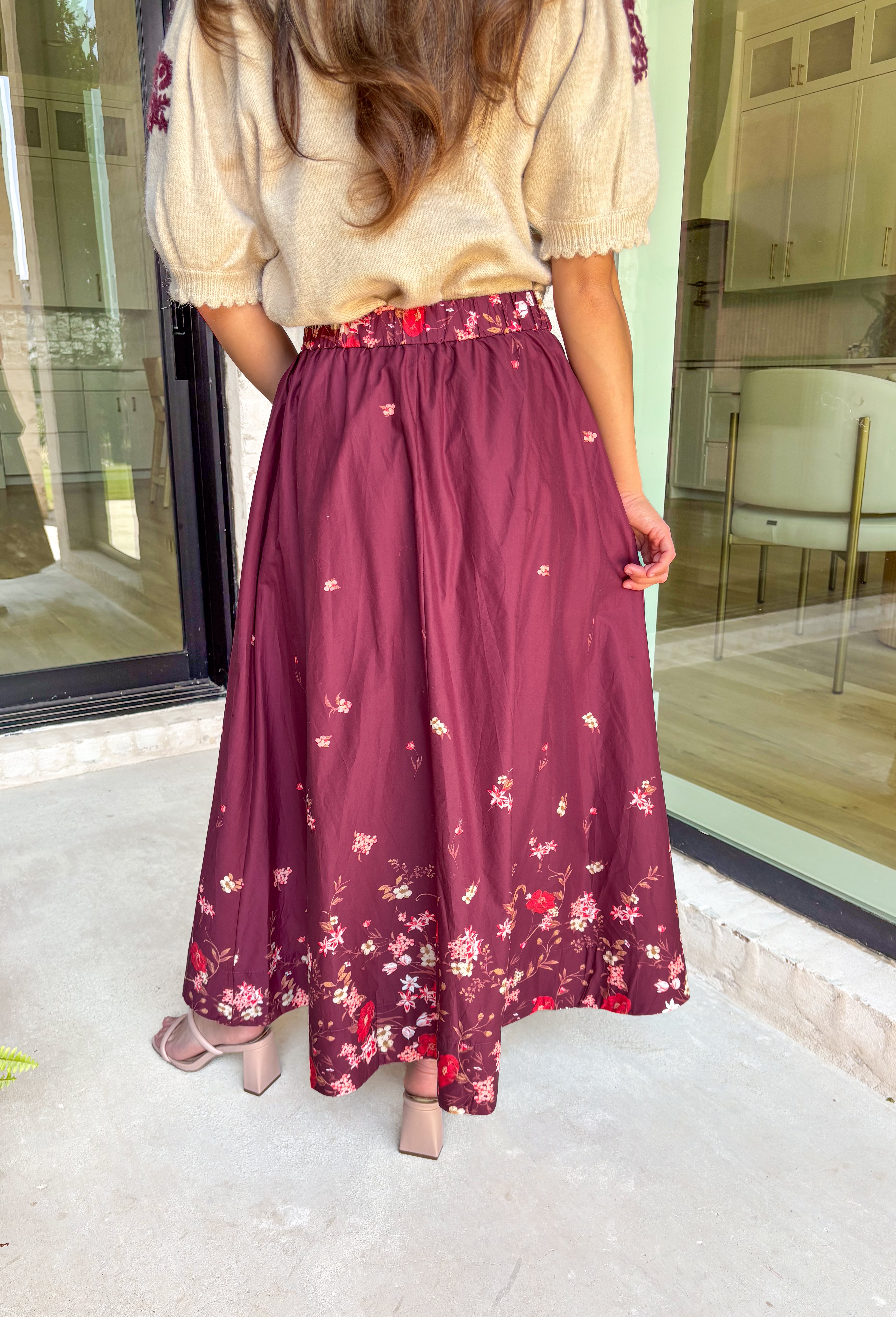 Feminine and flowy, this burgundy midi skirt is a seasonal standout. Designed with a floral border placement print, it adds just the right amount of charm while keeping the look timeless. The elasticated back waistband and side zipper closure make it comfortable and flattering, while side pockets add that everyday practicality we love. Fully lined in breathable cotton, this skirt is ready for everything from workdays to weekend strolls through the pumpkin patch.