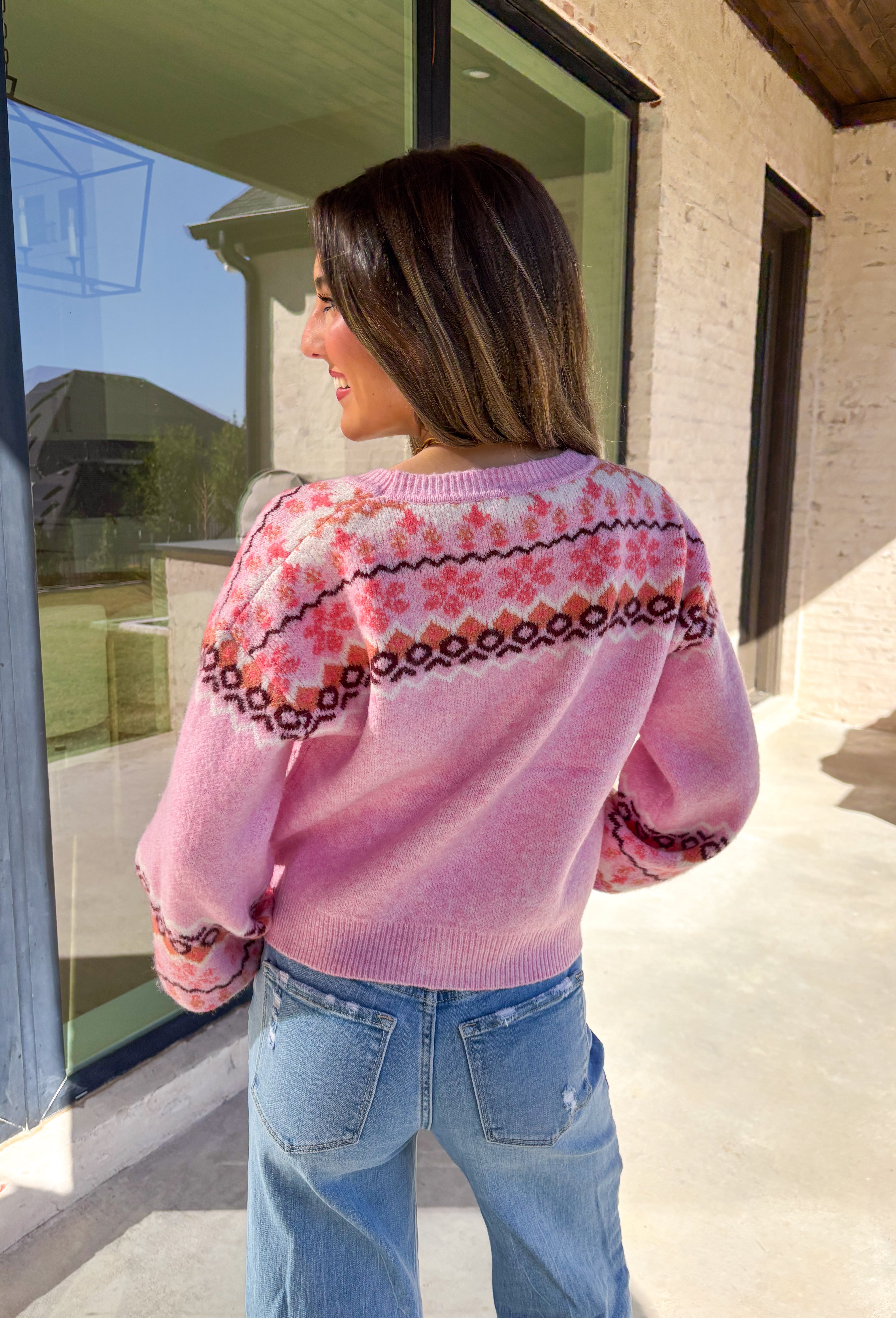 Sweet and cozy, this light pink cardigan by Skies Are Blue adds a touch of charm to your winter wardrobe. Featuring a soft Fair Isle pattern along the top and a cropped silhouette, this piece blends classic winter style with a playful twist. The front pockets and button-down design make it as functional as it is cute—perfect for layering on chilly days or adding warmth to festive outfits.