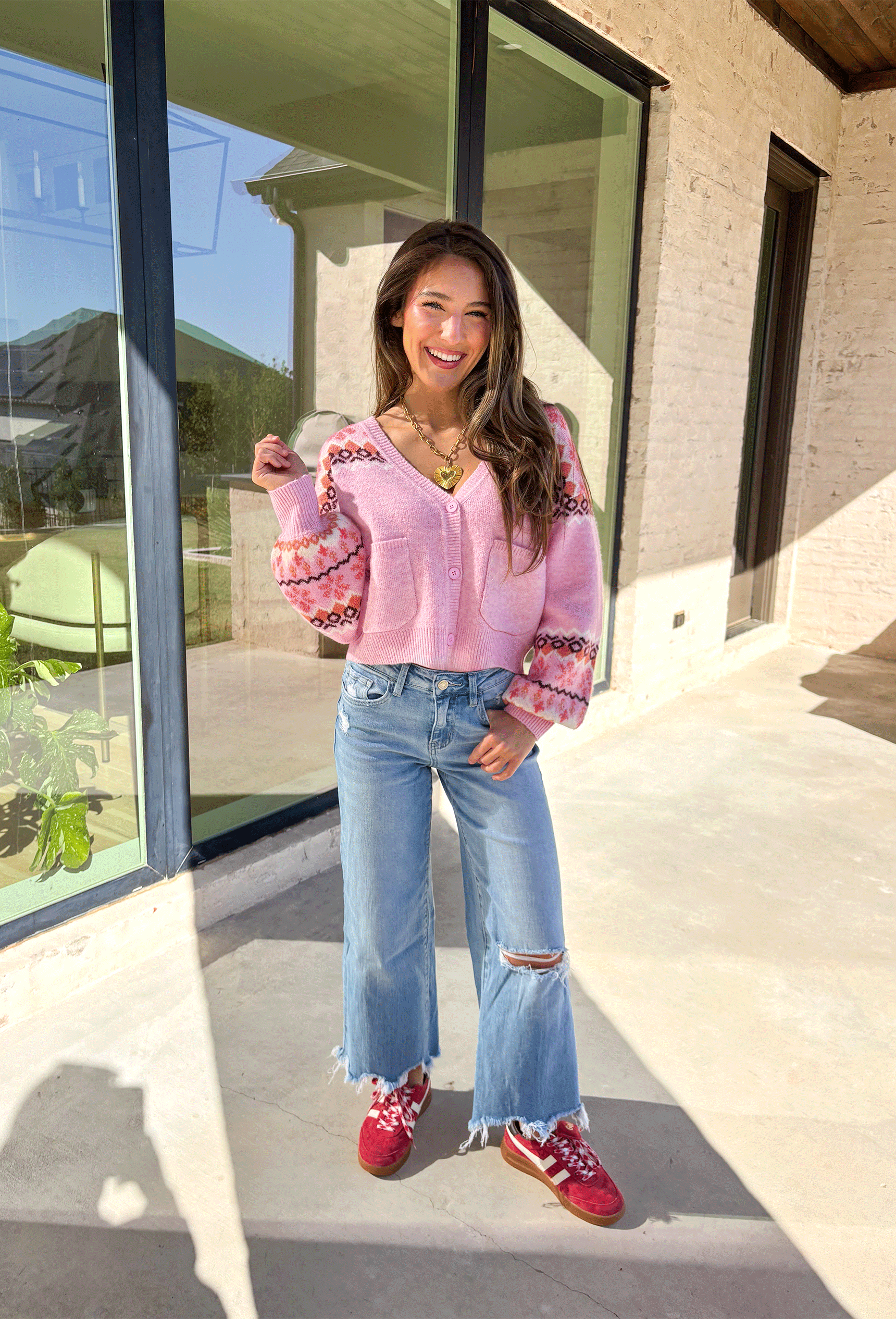 Sweet and cozy, this light pink cardigan by Skies Are Blue adds a touch of charm to your winter wardrobe. Featuring a soft Fair Isle pattern along the top and a cropped silhouette, this piece blends classic winter style with a playful twist. The front pockets and button-down design make it as functional as it is cute—perfect for layering on chilly days or adding warmth to festive outfits.