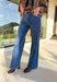 Add a touch of glam to your winter denim collection with these high-waisted wide leg jeans by Risen. Designed in a medium wash with striking black rhinestone detailing along the front, this pair blends everyday comfort with just the right amount of sparkle. The soft stretch denim and flattering wide leg silhouette make them perfect for dressing up or down all season long.