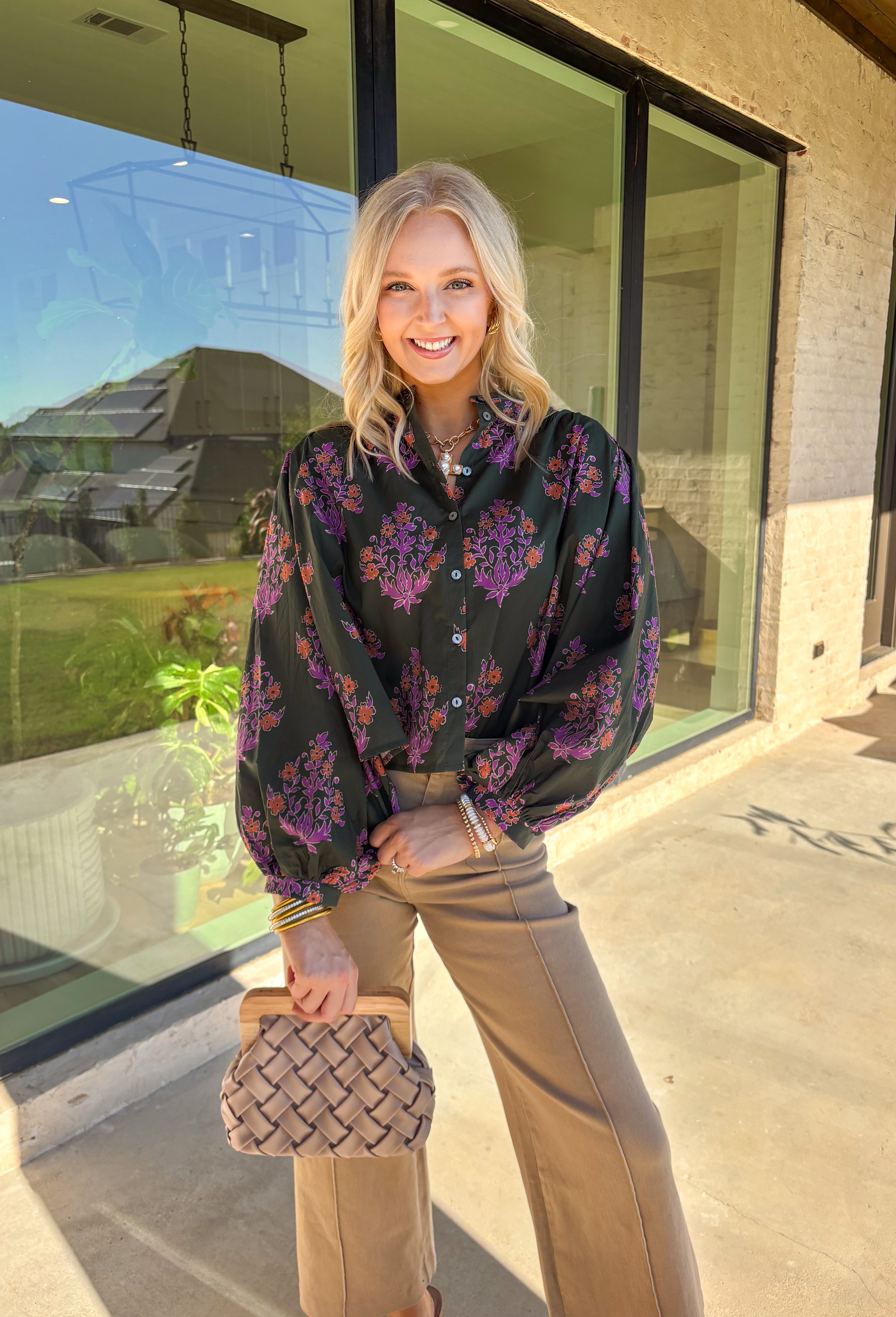 This dark green button-down top by Entro blends classic design with a seasonal twist. Featuring a lively orange and purple floral print, it adds just the right pop of color while keeping things effortless and chic. The breathable 100% cotton fabric makes it comfortable enough for everyday wear, and the button-front style gives you plenty of ways to layer and style it through the season. Perfect for bringing a touch of fall flair to your wardrobe.
