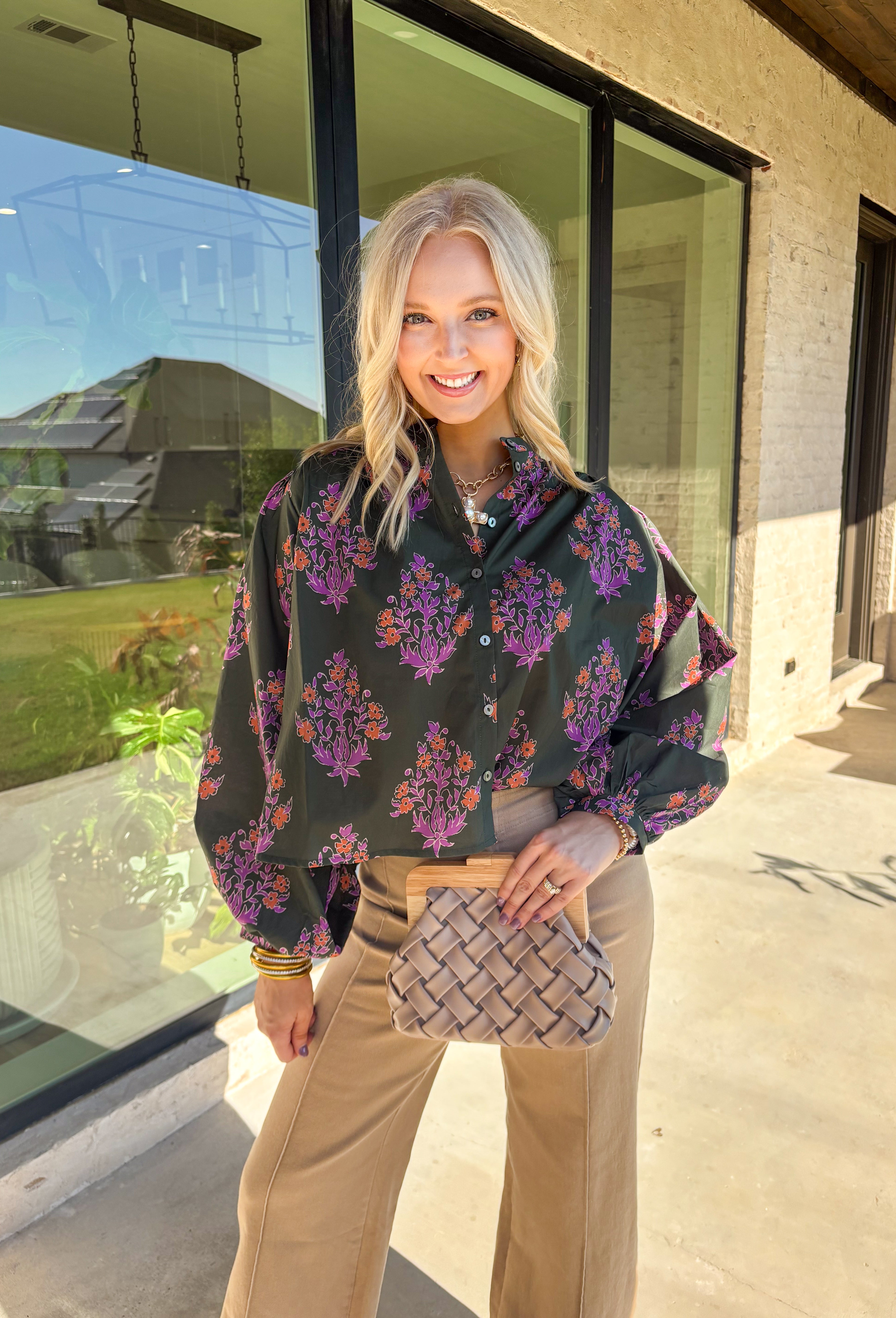 This dark green button-down top by Entro blends classic design with a seasonal twist. Featuring a lively orange and purple floral print, it adds just the right pop of color while keeping things effortless and chic. The breathable 100% cotton fabric makes it comfortable enough for everyday wear, and the button-front style gives you plenty of ways to layer and style it through the season. Perfect for bringing a touch of fall flair to your wardrobe.