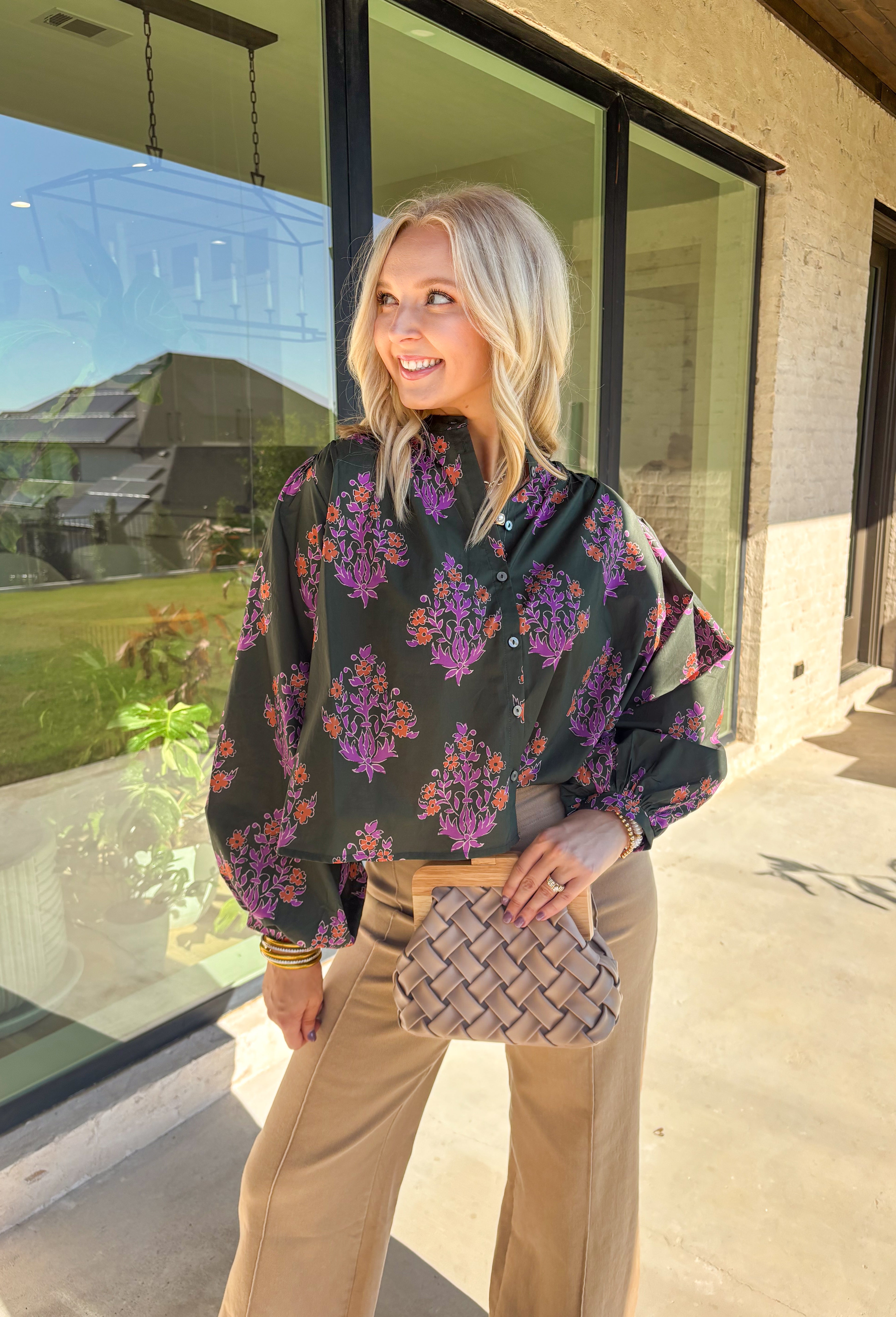 This dark green button-down top by Entro blends classic design with a seasonal twist. Featuring a lively orange and purple floral print, it adds just the right pop of color while keeping things effortless and chic. The breathable 100% cotton fabric makes it comfortable enough for everyday wear, and the button-front style gives you plenty of ways to layer and style it through the season. Perfect for bringing a touch of fall flair to your wardrobe.