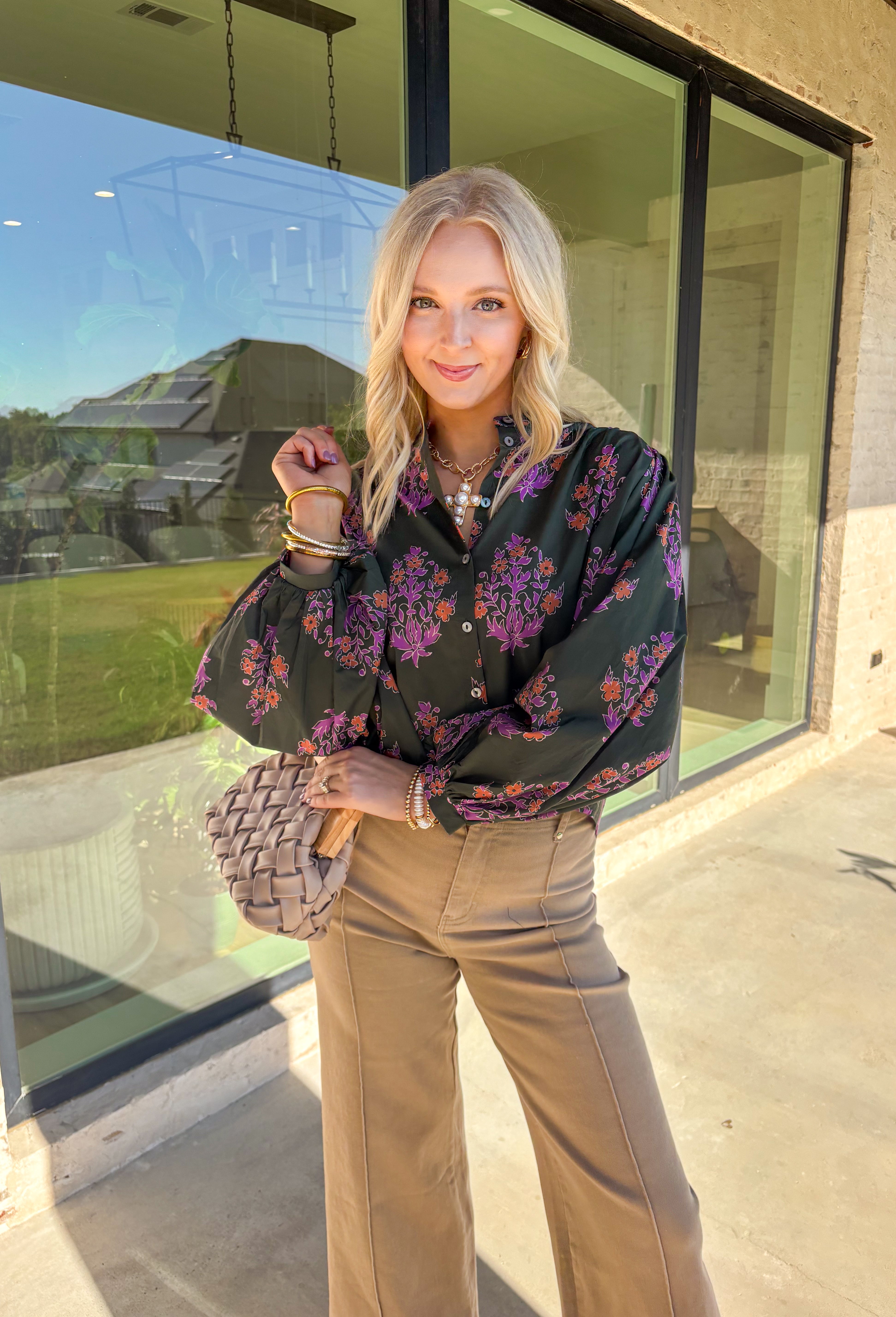 This dark green button-down top by Entro blends classic design with a seasonal twist. Featuring a lively orange and purple floral print, it adds just the right pop of color while keeping things effortless and chic. The breathable 100% cotton fabric makes it comfortable enough for everyday wear, and the button-front style gives you plenty of ways to layer and style it through the season. Perfect for bringing a touch of fall flair to your wardrobe.