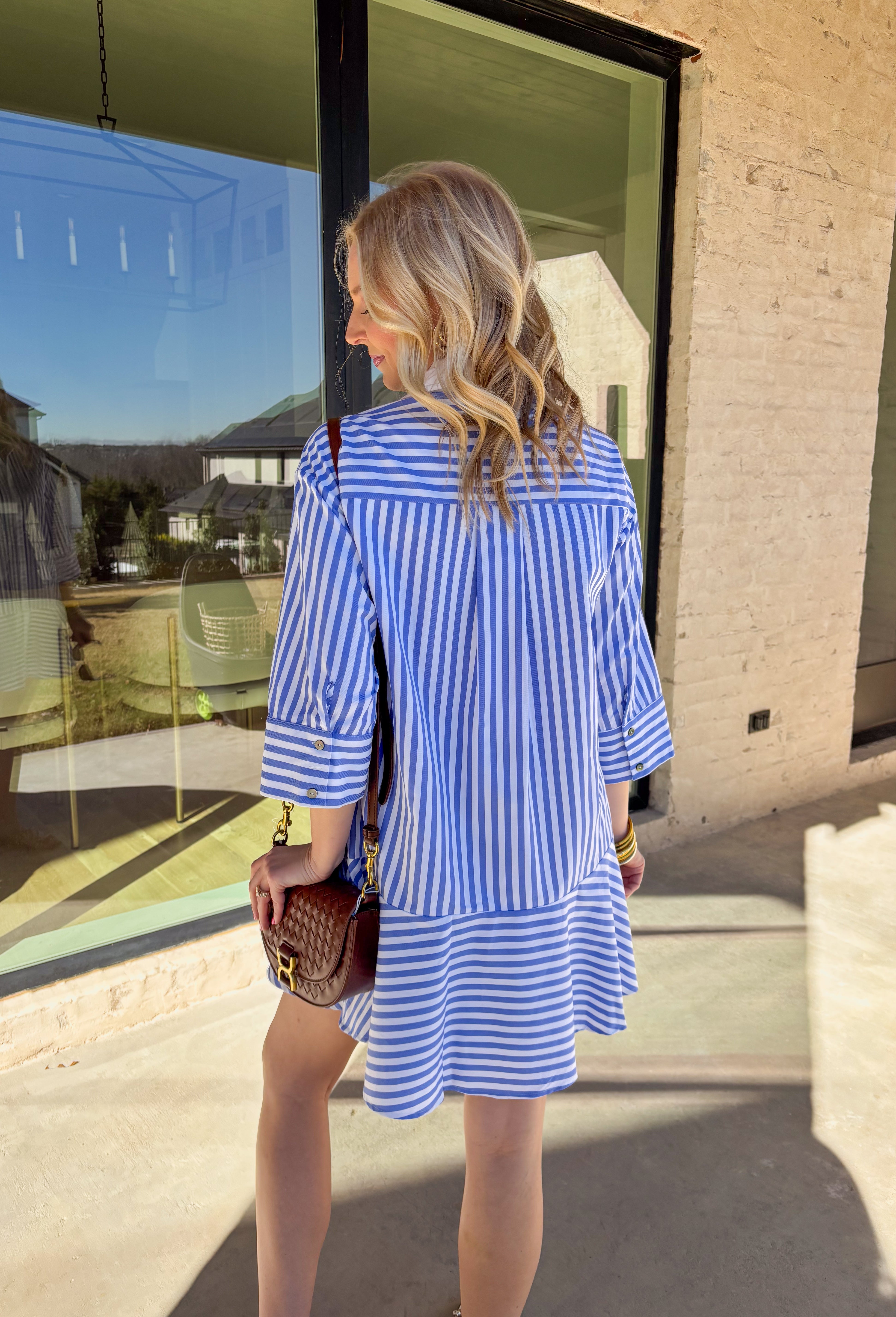 Bright, cheerful, and perfect for spring days, this blue and white striped long sleeve dress brings an easy, sunshine-filled feel to your wardrobe. The classic stripe pattern feels fresh and timeless, while the button-down design with a crisp white band and collared neckline adds a polished touch. Fully lined for comfortable wear, this dress is an effortless option for brunch, daytime events, or spring outings.