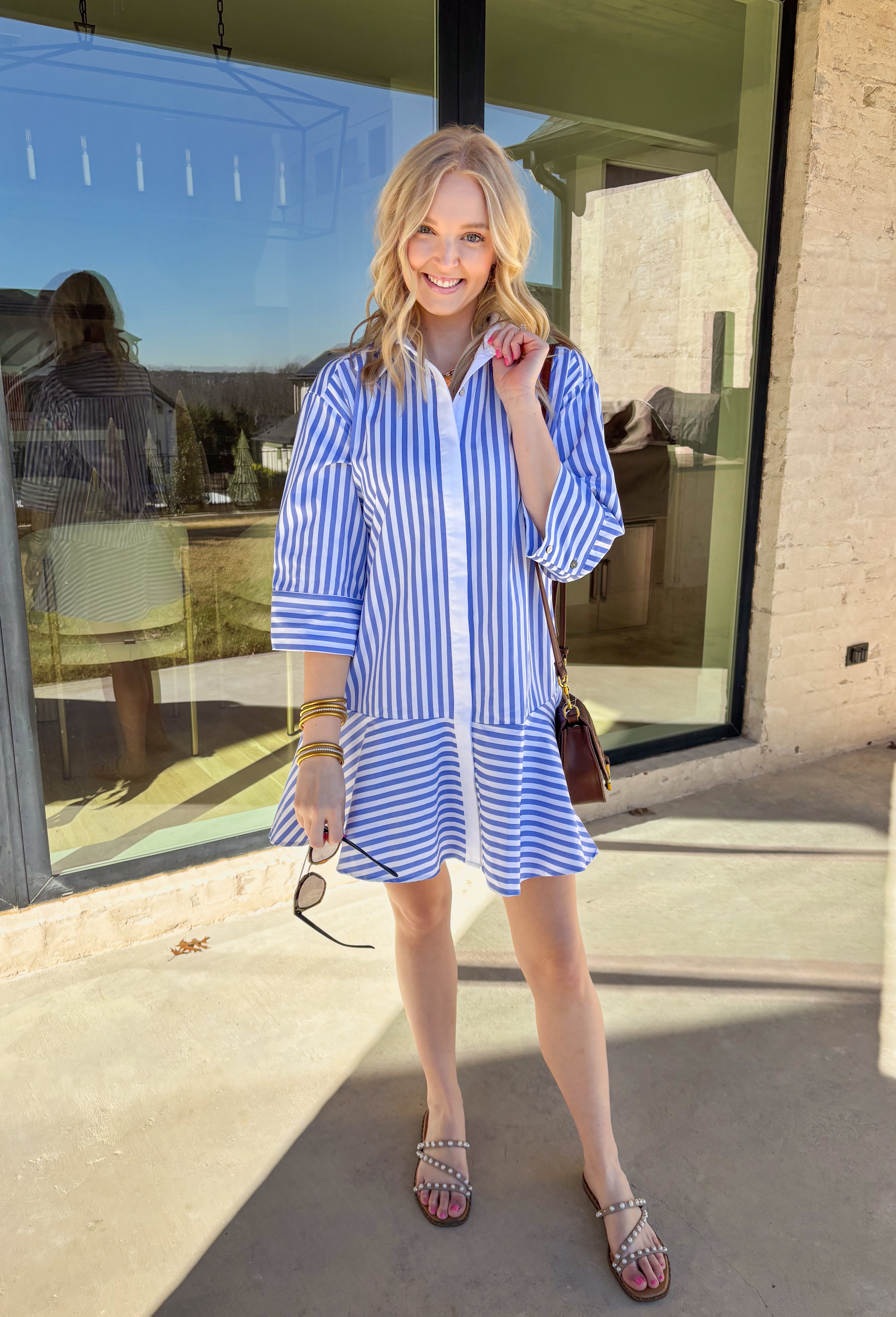 Bright, cheerful, and perfect for spring days, this blue and white striped long sleeve dress brings an easy, sunshine-filled feel to your wardrobe. The classic stripe pattern feels fresh and timeless, while the button-down design with a crisp white band and collared neckline adds a polished touch. Fully lined for comfortable wear, this dress is an effortless option for brunch, daytime events, or spring outings.