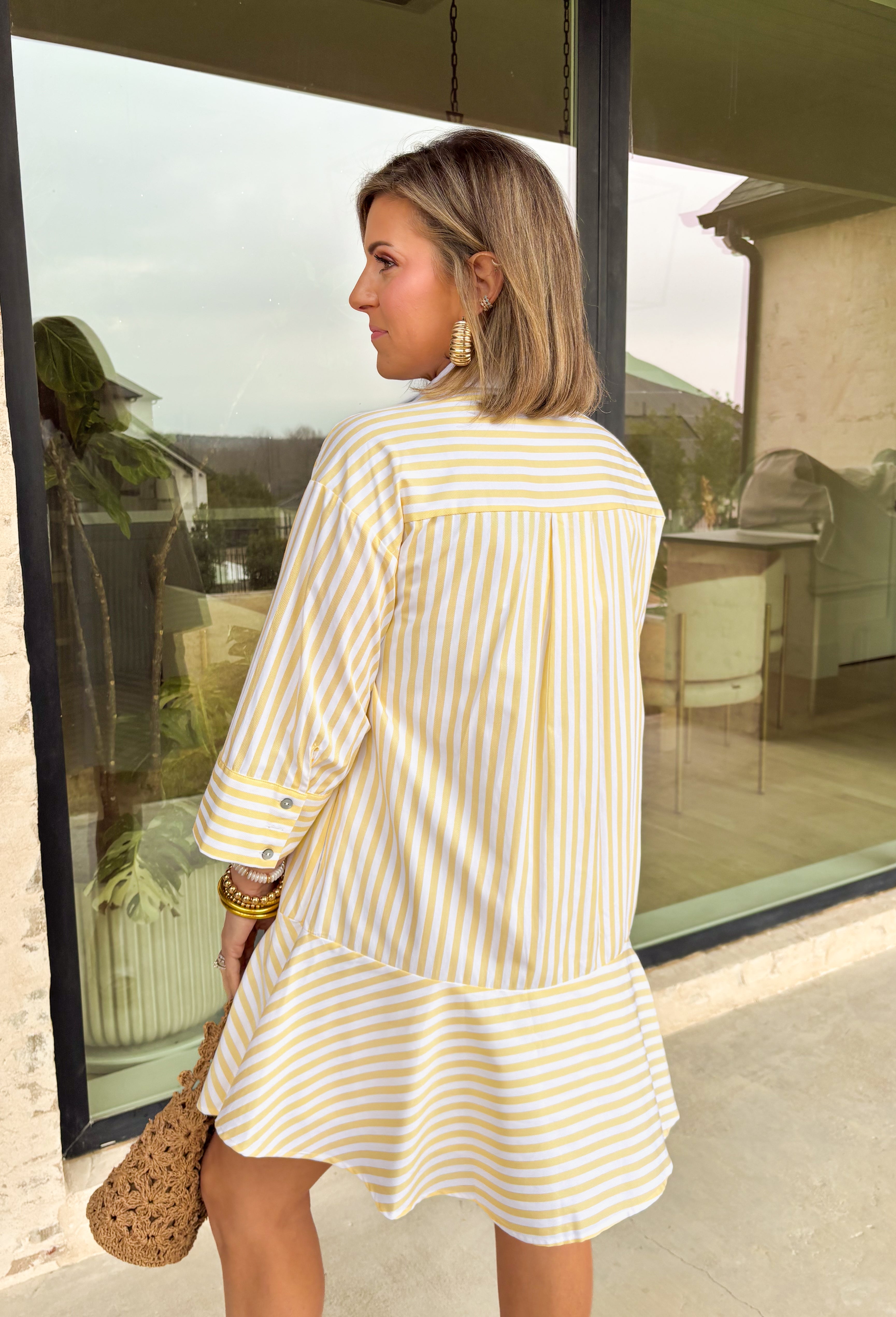 Bright, cheerful, and perfect for spring days, this yellow and white striped long sleeve dress brings an easy, sunshine-filled feel to your wardrobe. The classic stripe pattern feels fresh and timeless, while the button-down design with a crisp white band and collared neckline adds a polished touch. Fully lined for comfortable wear, this dress is an effortless option for brunch, daytime events, or spring outings.