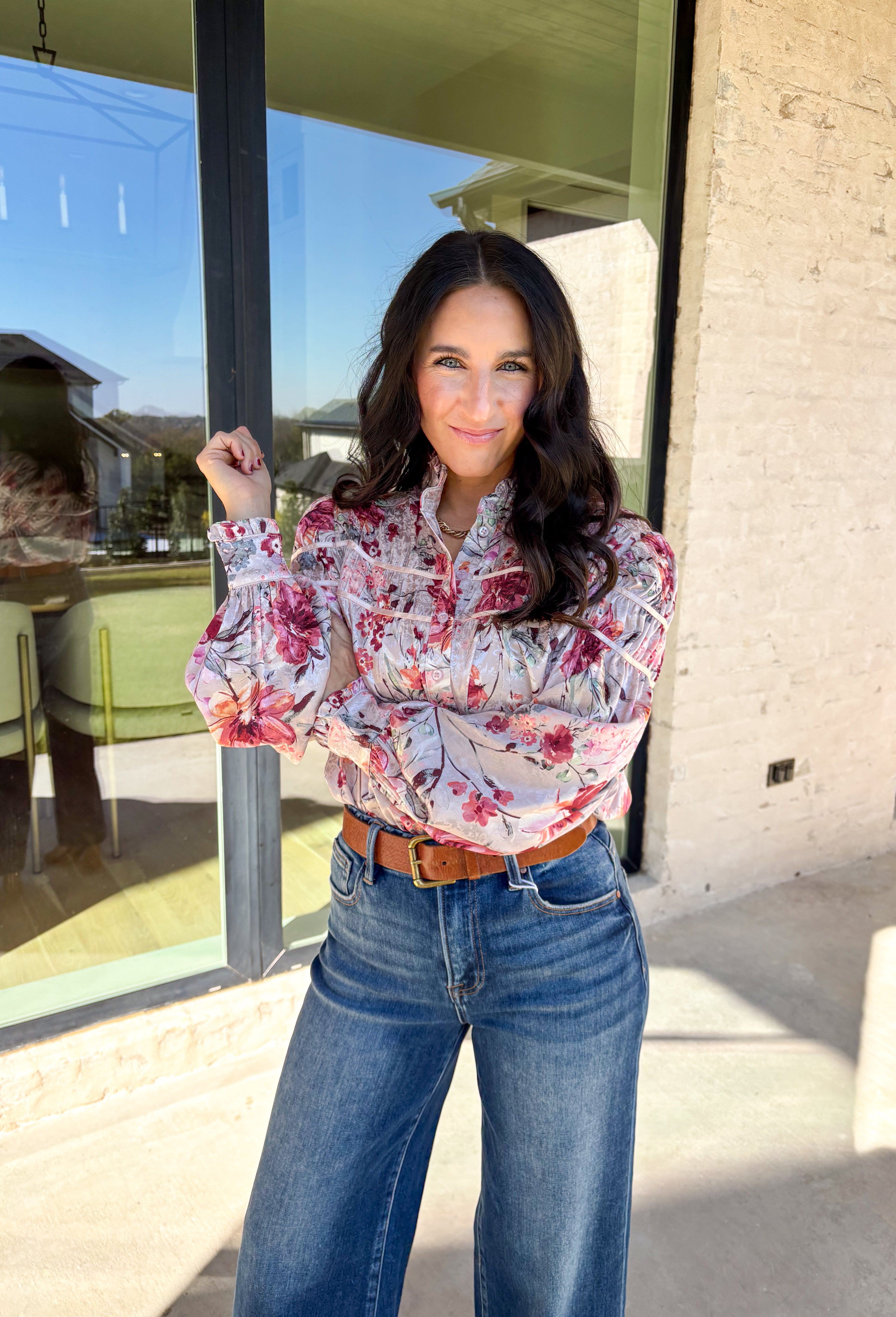 Bring a touch of winter romance to your wardrobe with this mauve floral button-down top by Fate. Featuring shades of pink, burgundy, gray, and orange, the floral print adds a warm pop of color against the chilly season. The ruffled neckline and cuffs give it a soft, feminine finish—perfect for dressing up denim or layering under a structured jacket all winter long.