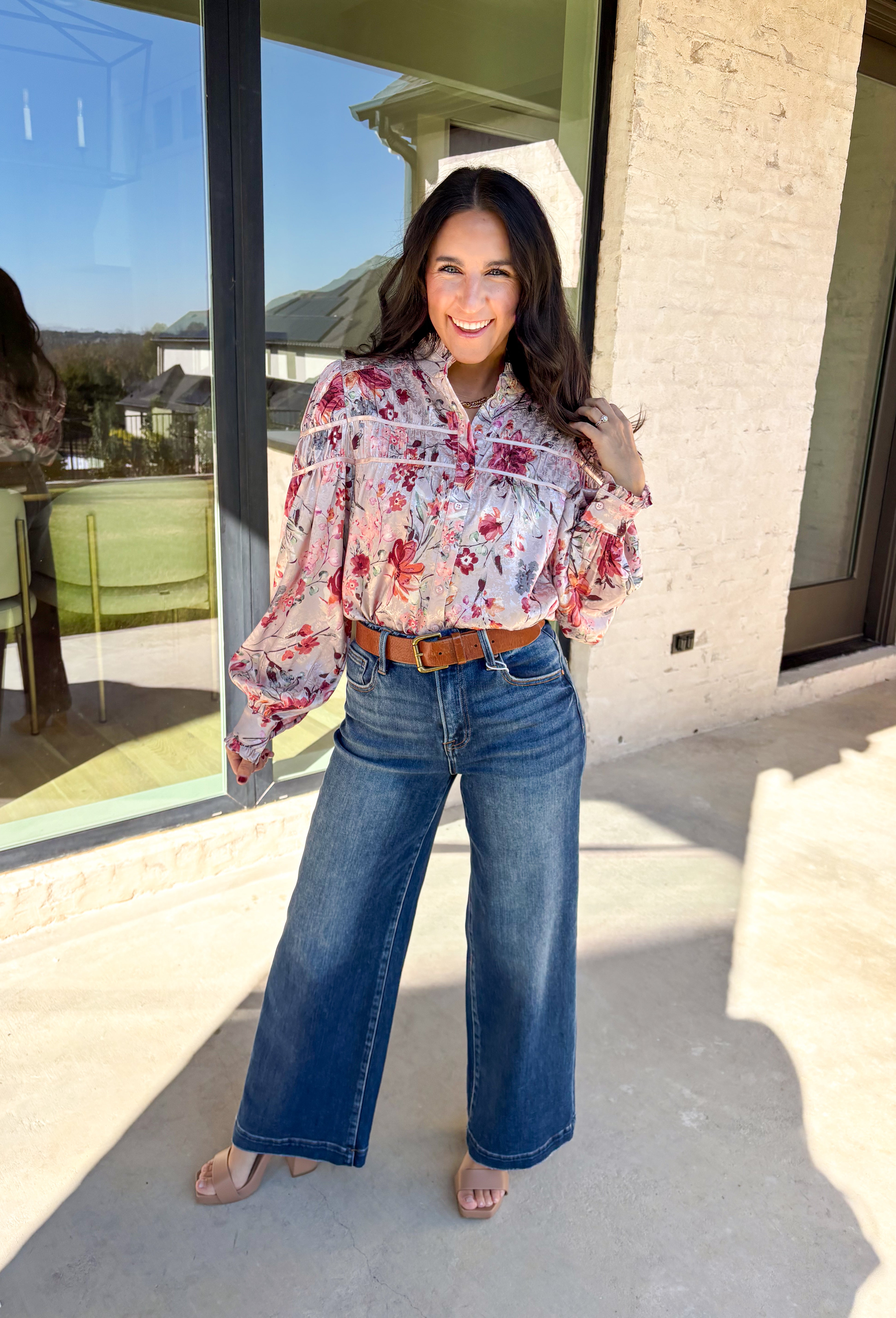 Bring a touch of winter romance to your wardrobe with this mauve floral button-down top by Fate. Featuring shades of pink, burgundy, gray, and orange, the floral print adds a warm pop of color against the chilly season. The ruffled neckline and cuffs give it a soft, feminine finish—perfect for dressing up denim or layering under a structured jacket all winter long.