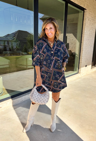Denim gets a colorful fall refresh with this printed dress from Entro. The denim fabric is covered in a beautiful floral print featuring shades of autumn, giving a classic favorite a fun seasonal twist. A collared neckline and button-front closure bring in that timeless shirt dress feel, while long sleeves make it an easy choice as cooler weather rolls in. Convenient side pockets add an everyday touch, and the cotton-blend fabric has just a hint of stretch for comfortable wear. 