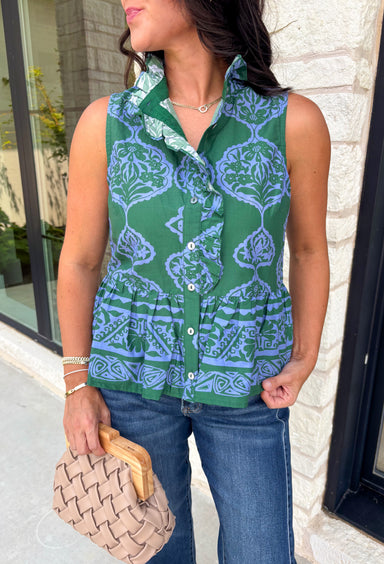 Bring a fresh pop of color to your fall wardrobe with this effortlessly charming paisley top. Featuring a beautiful green backdrop with a light blue paisley print, this sleeveless blouse is equal parts classic and feminine. The ruffled neckline and button-front details add a polished touch, while the peplum hem creates a flattering silhouette that's easy to wear from workdays to weekends. 