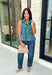 Bring a fresh pop of color to your fall wardrobe with this effortlessly charming paisley top. Featuring a beautiful green backdrop with a light blue paisley print, this sleeveless blouse is equal parts classic and feminine. The ruffled neckline and button-front details add a polished touch, while the peplum hem creates a flattering silhouette that's easy to wear from workdays to weekends. 