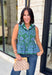 Bring a fresh pop of color to your fall wardrobe with this effortlessly charming paisley top. Featuring a beautiful green backdrop with a light blue paisley print, this sleeveless blouse is equal parts classic and feminine. The ruffled neckline and button-front details add a polished touch, while the peplum hem creates a flattering silhouette that's easy to wear from workdays to weekends. 