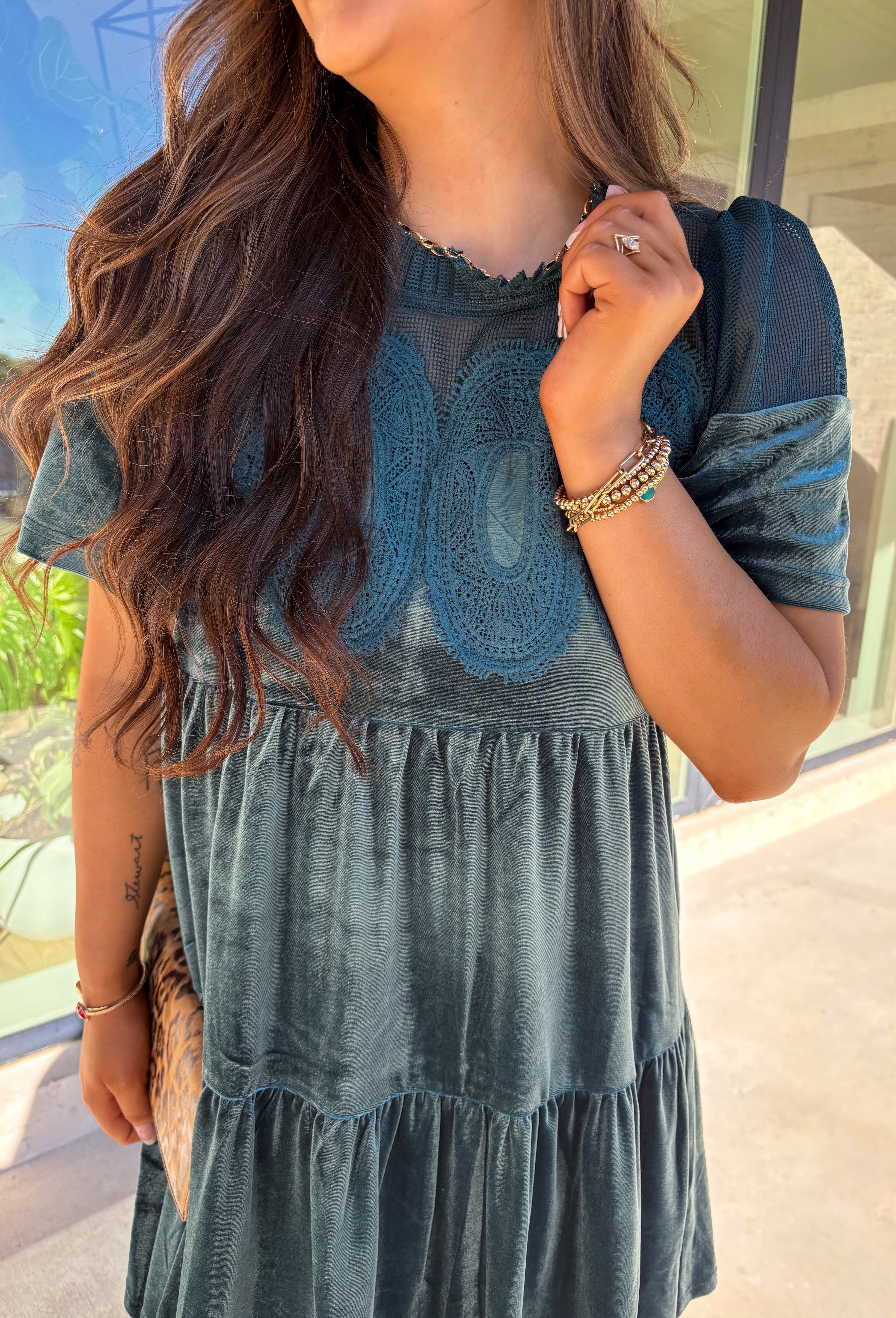 This tiered teal green crushed velvet dress by Fate is a showstopper for the season. Designed with rich texture and romantic details, it features open crochet accents along the top with oval-shaped embroidered lace appliqués for a stunning finish. The soft velvet fabric and fully lined interior make it as comfortable as it is elegant—perfect for the holiday season!