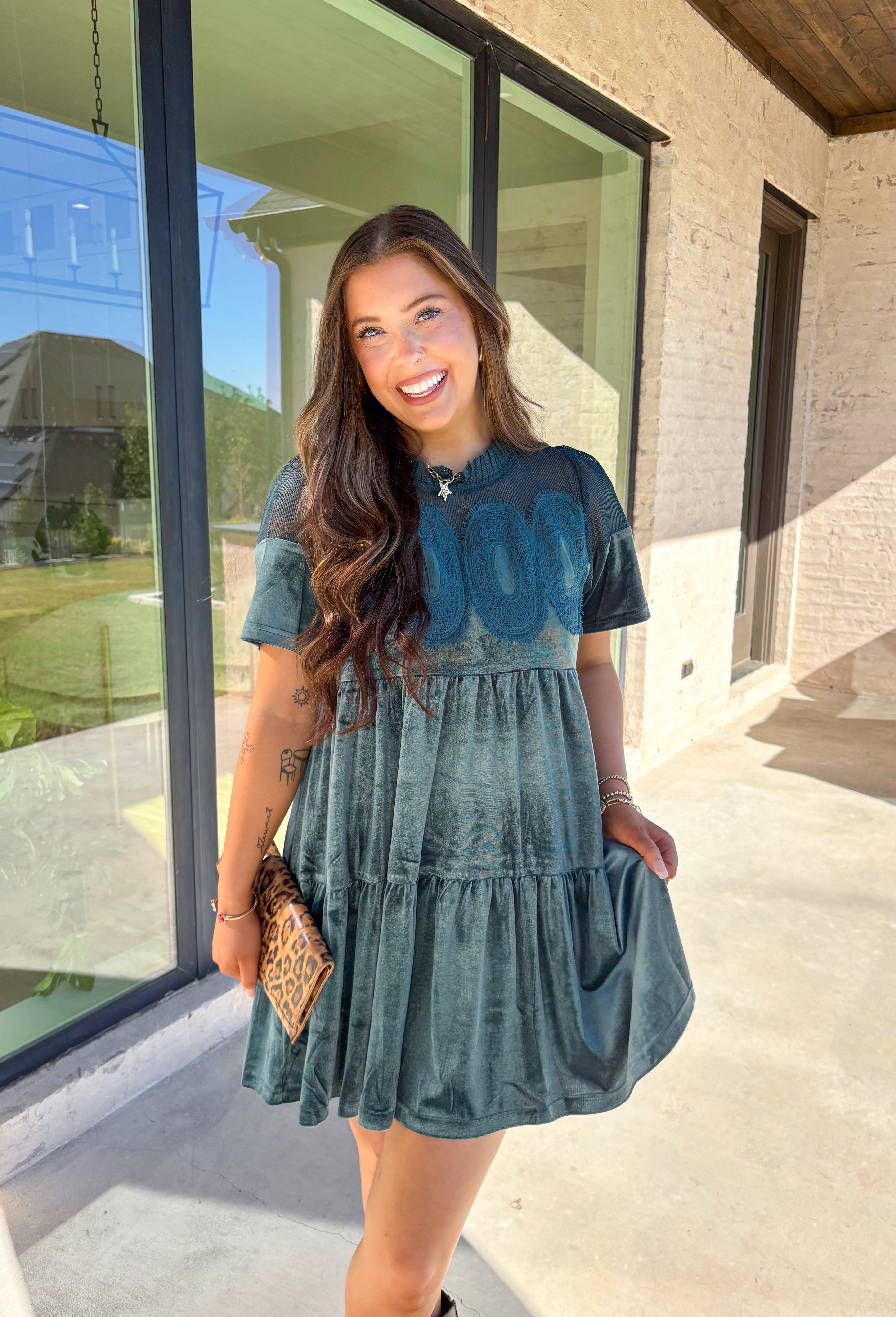 This tiered teal green crushed velvet dress by Fate is a showstopper for the season. Designed with rich texture and romantic details, it features open crochet accents along the top with oval-shaped embroidered lace appliqués for a stunning finish. The soft velvet fabric and fully lined interior make it as comfortable as it is elegant—perfect for the holiday season!