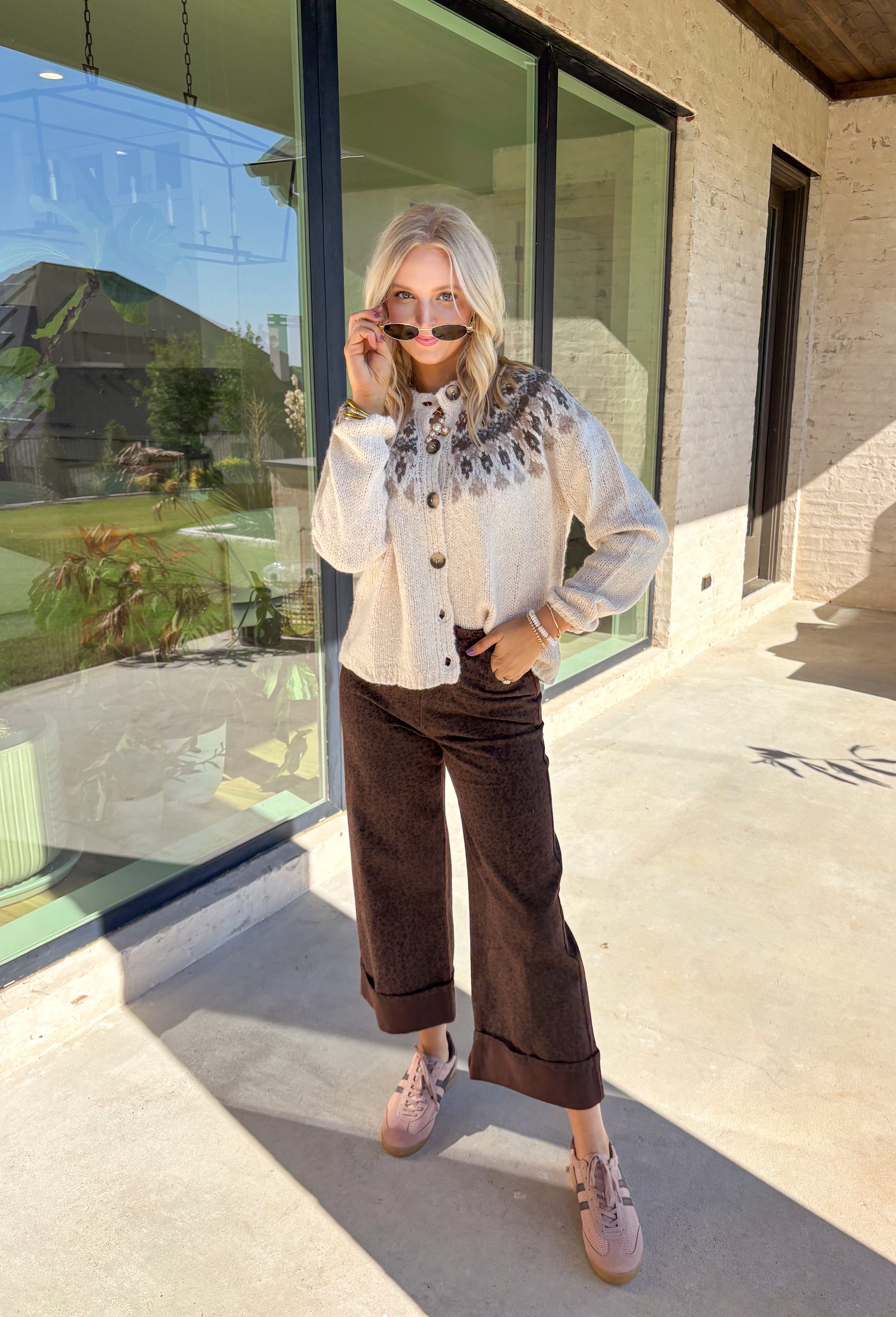 Add a pop of cozy charm to your wardrobe with this chunky knit button-down cardigan by Blu Pepper. Featuring a round neckline and long sleeves, it’s designed with a vibrant Fair Isle pattern in neutral tones—making it an easy piece to mix and match with your seasonal staples. Finished with a button-front closure, it’s just as easy to wear open as it is closed, giving you endless layering possibilities. Warm yet breathable, this cardigan is perfect for styling through the season.