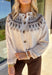 Add a pop of cozy charm to your wardrobe with this chunky knit button-down cardigan by Blu Pepper. Featuring a round neckline and long sleeves, it’s designed with a vibrant Fair Isle pattern in neutral tones—making it an easy piece to mix and match with your seasonal staples. Finished with a button-front closure, it’s just as easy to wear open as it is closed, giving you endless layering possibilities. Warm yet breathable, this cardigan is perfect for styling through the season.