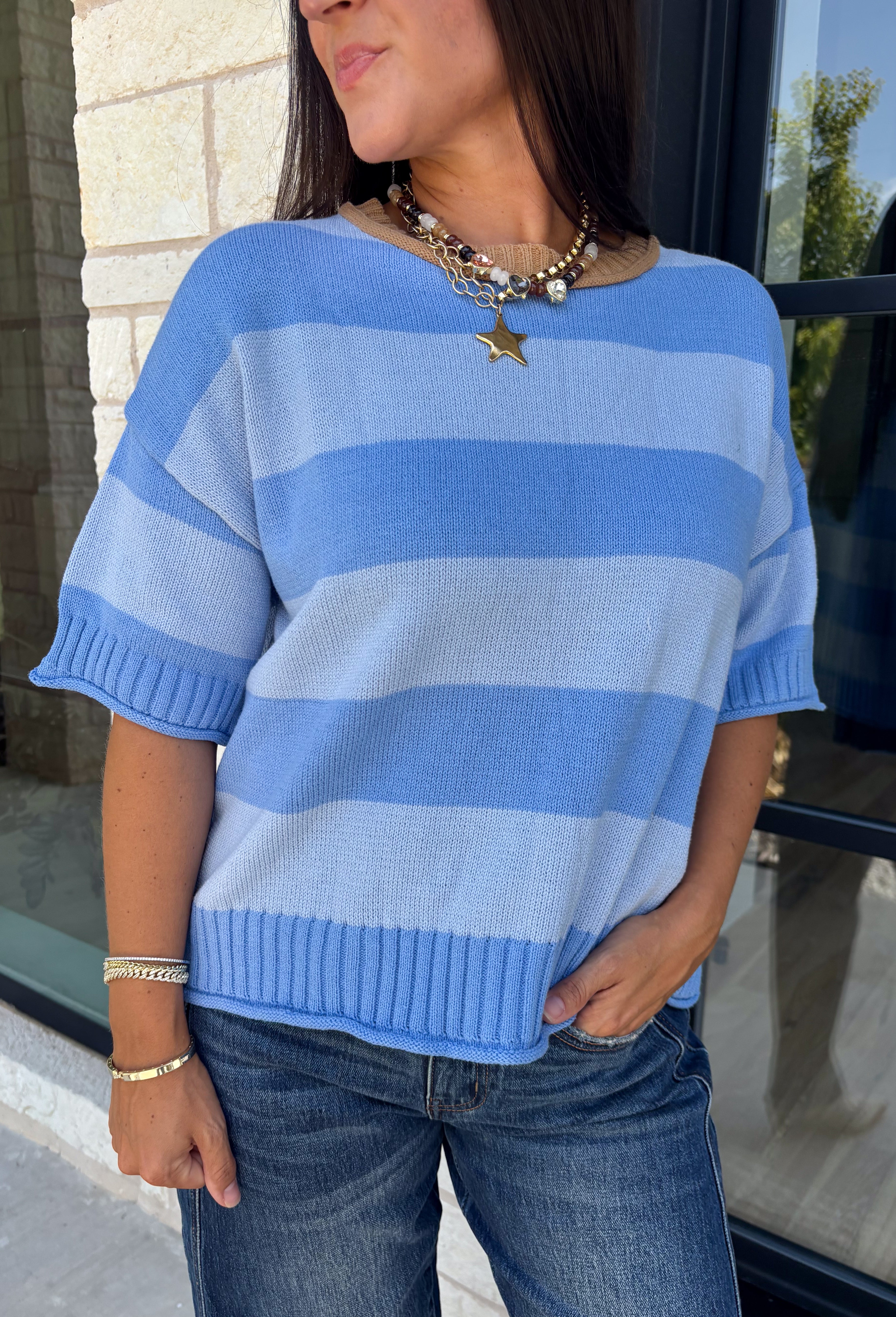 Soft, cozy, and effortlessly classic, this striped sweater is the perfect piece for transitioning into fall! Featuring light blue stripes with warm tan trim along the neckline, this knit blends timeless style with a fresh seasonal color palette. Ribbed detailing at the sleeves and hem adds a polished finish, while the breathable cotton blend keeps it comfortable for layering or wearing on its own. 