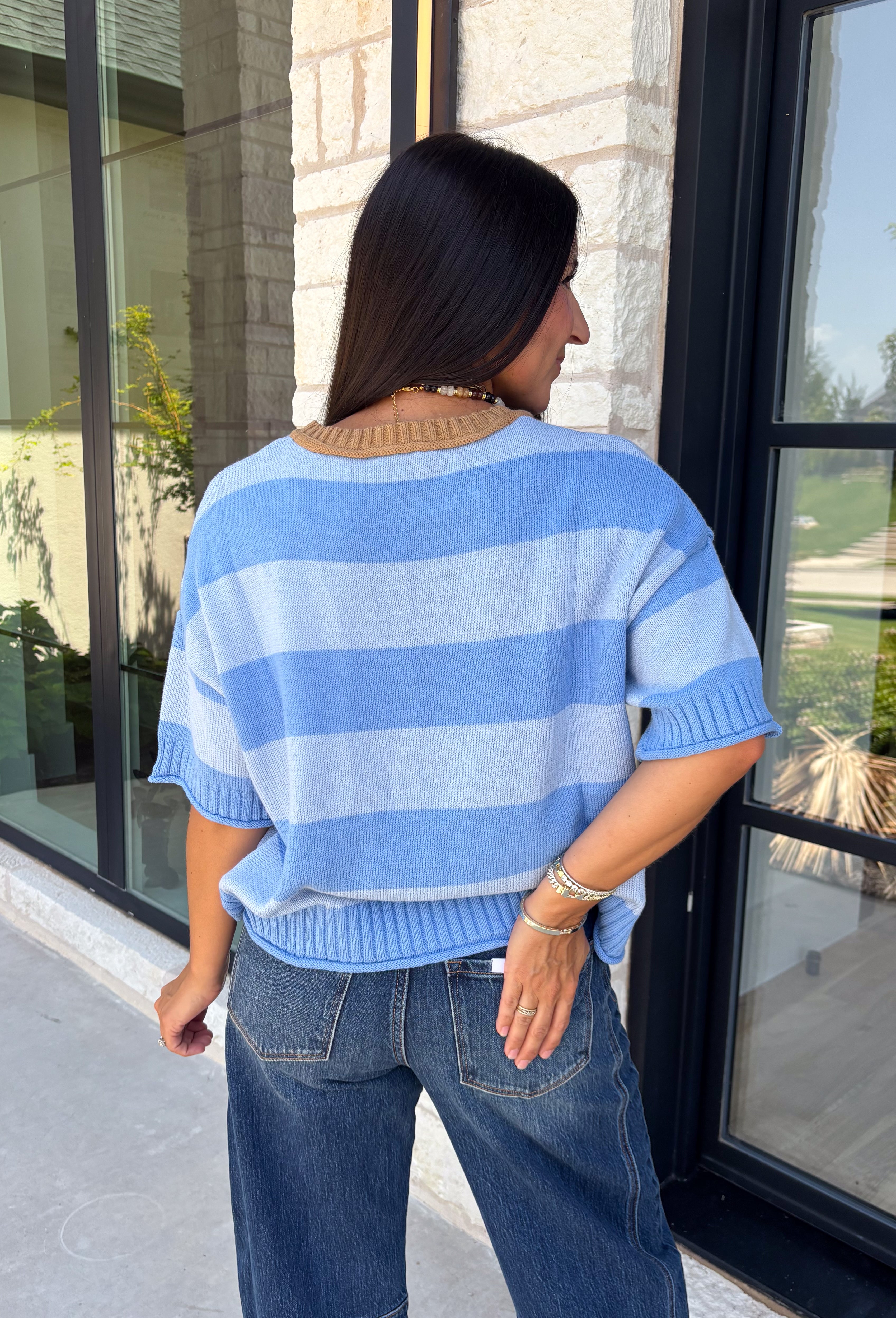 Soft, cozy, and effortlessly classic, this striped sweater is the perfect piece for transitioning into fall! Featuring light blue stripes with warm tan trim along the neckline, this knit blends timeless style with a fresh seasonal color palette. Ribbed detailing at the sleeves and hem adds a polished finish, while the breathable cotton blend keeps it comfortable for layering or wearing on its own. 