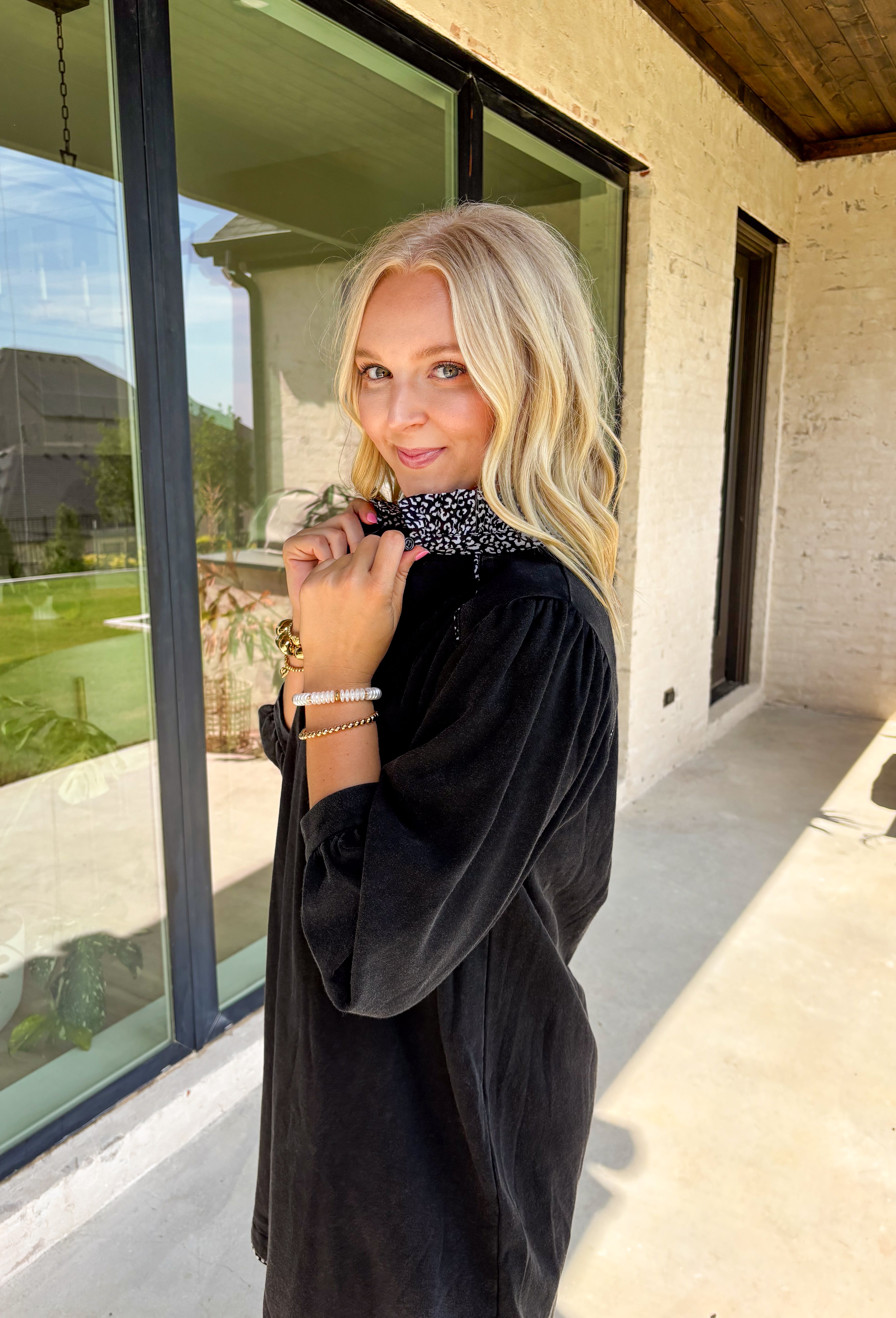 Classic black gets a playful twist in this long sleeve dress featuring subtle leopard details. The black and white leopard print peeks out along the ruffle-trimmed neckline and hem, adding just the right amount of contrast. With its relaxed fit and comfortable cotton blend, this dress is easy to wear from day to night—perfect for adding a little personality to your wardrobe.