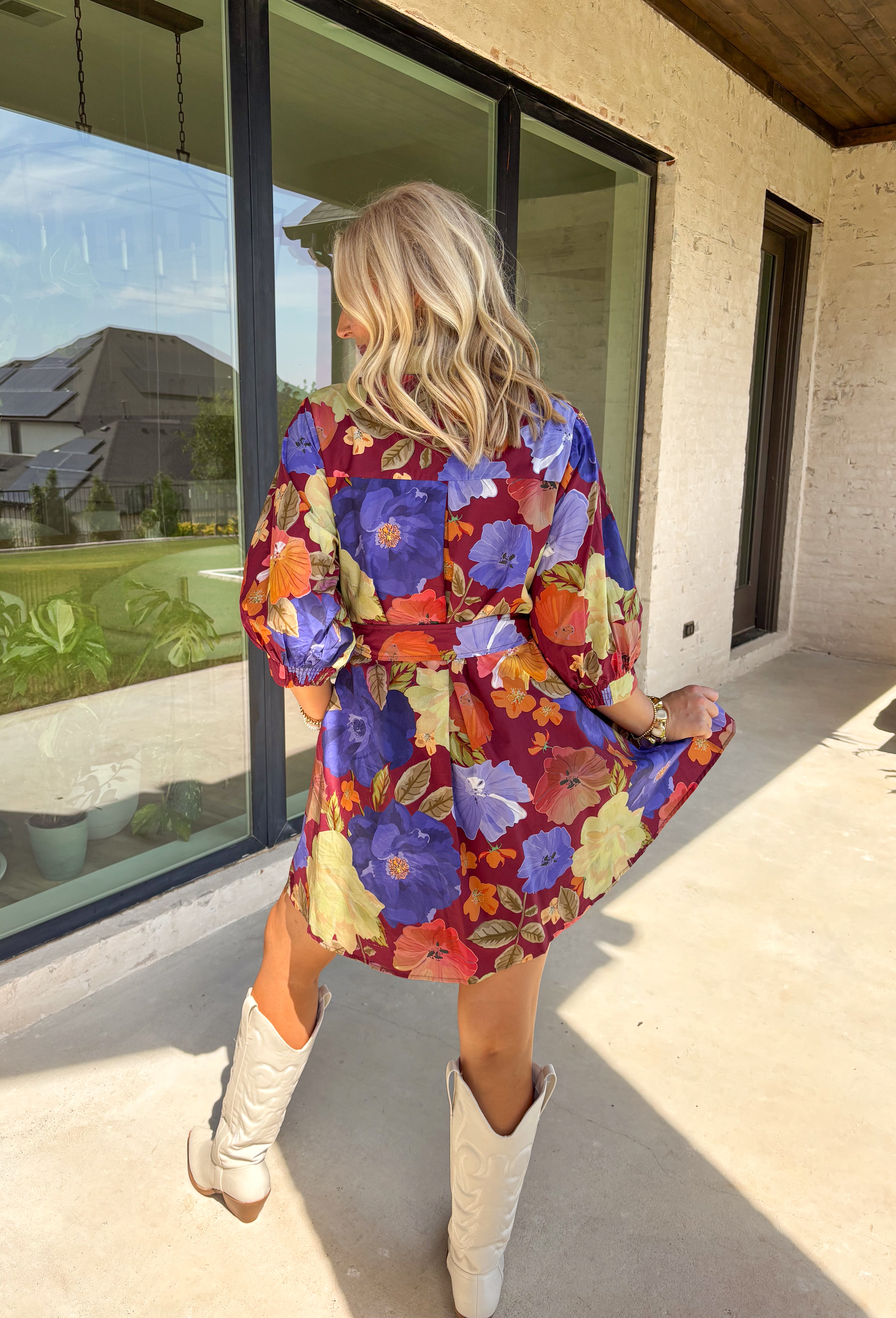 A fall favorite with effortless charm, this burgundy mini dress is blooming with autumn-inspired florals. The puff sleeves give it a feminine touch, while a front chest pocket and self-tie waist add both function and shape. Designed with a button-front closure, side pockets, and a fully lined interior, this dress is as practical as it is pretty. Made in breathable cotton, it’s an easy piece to style for everything from casual days to seasonal gatherings.