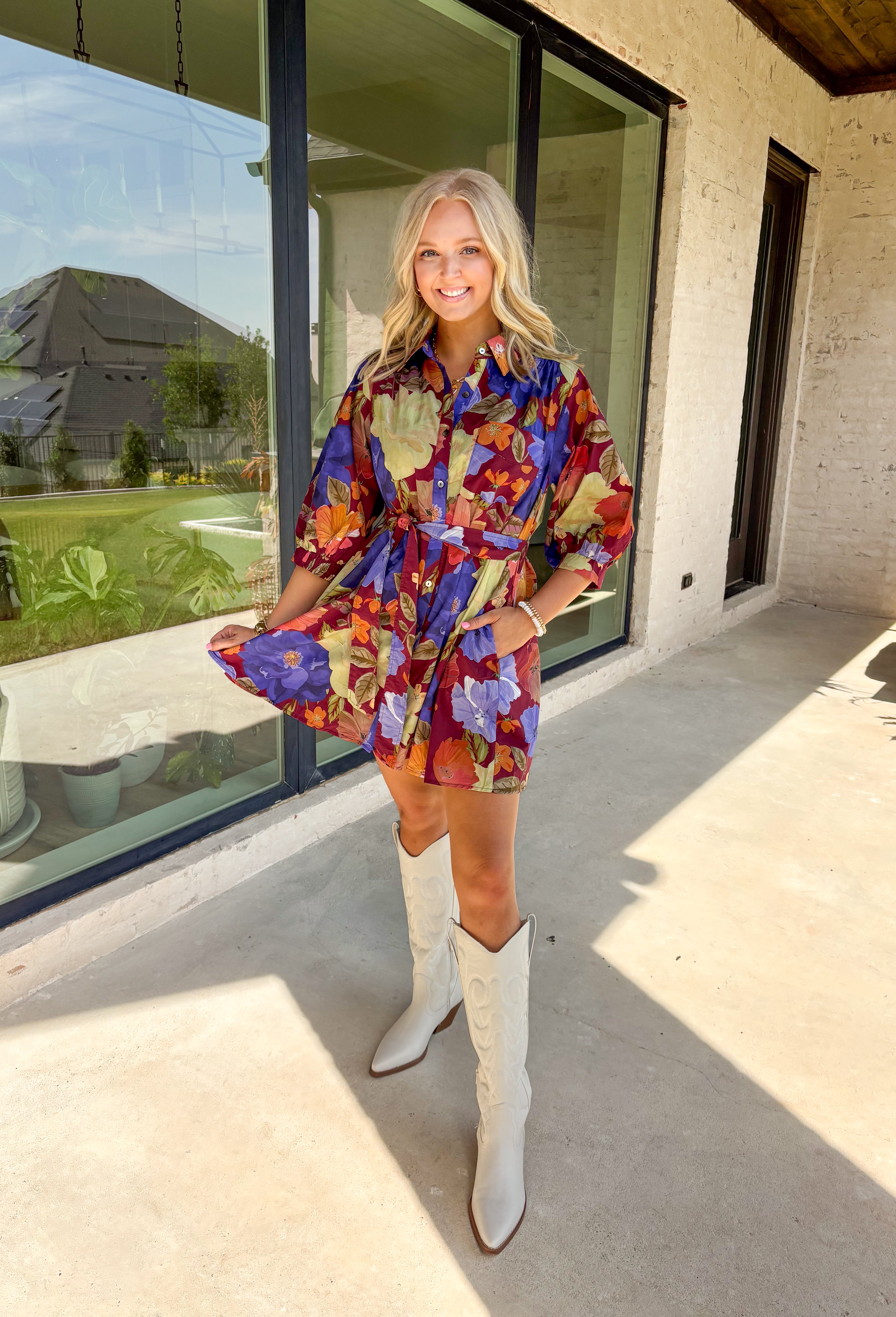 A fall favorite with effortless charm, this burgundy mini dress is blooming with autumn-inspired florals. The puff sleeves give it a feminine touch, while a front chest pocket and self-tie waist add both function and shape. Designed with a button-front closure, side pockets, and a fully lined interior, this dress is as practical as it is pretty. Made in breathable cotton, it’s an easy piece to style for everything from casual days to seasonal gatherings.