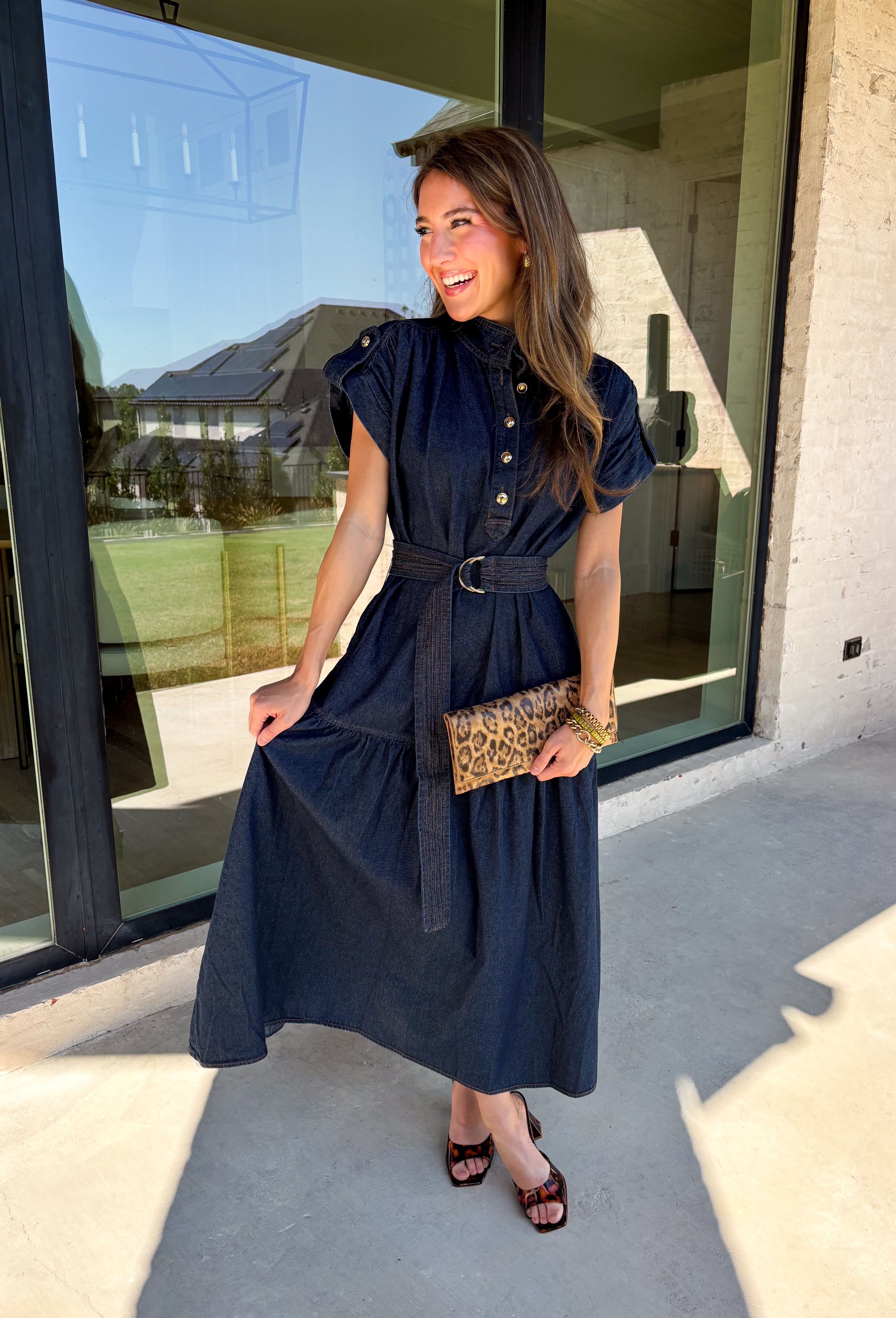 There’s something about a great denim dress that makes getting dressed feel instantly easier. This dark wash midi dress from Entro features a stand collar and partial gold button front that adds a polished touch to the classic denim look. Cap sleeves keep the silhouette easy to layer as the seasons change, while the coordinating self-tie belt lets you add definition at the waist. Finished with convenient side pockets, this versatile dress can take you from casual office days and lunch plans to football week