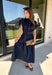There’s something about a great denim dress that makes getting dressed feel instantly easier. This dark wash midi dress from Entro features a stand collar and partial gold button front that adds a polished touch to the classic denim look. Cap sleeves keep the silhouette easy to layer as the seasons change, while the coordinating self-tie belt lets you add definition at the waist. Finished with convenient side pockets, this versatile dress can take you from casual office days and lunch plans to football week