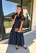 There’s something about a great denim dress that makes getting dressed feel instantly easier. This dark wash midi dress from Entro features a stand collar and partial gold button front that adds a polished touch to the classic denim look. Cap sleeves keep the silhouette easy to layer as the seasons change, while the coordinating self-tie belt lets you add definition at the waist. Finished with convenient side pockets, this versatile dress can take you from casual office days and lunch plans to football week