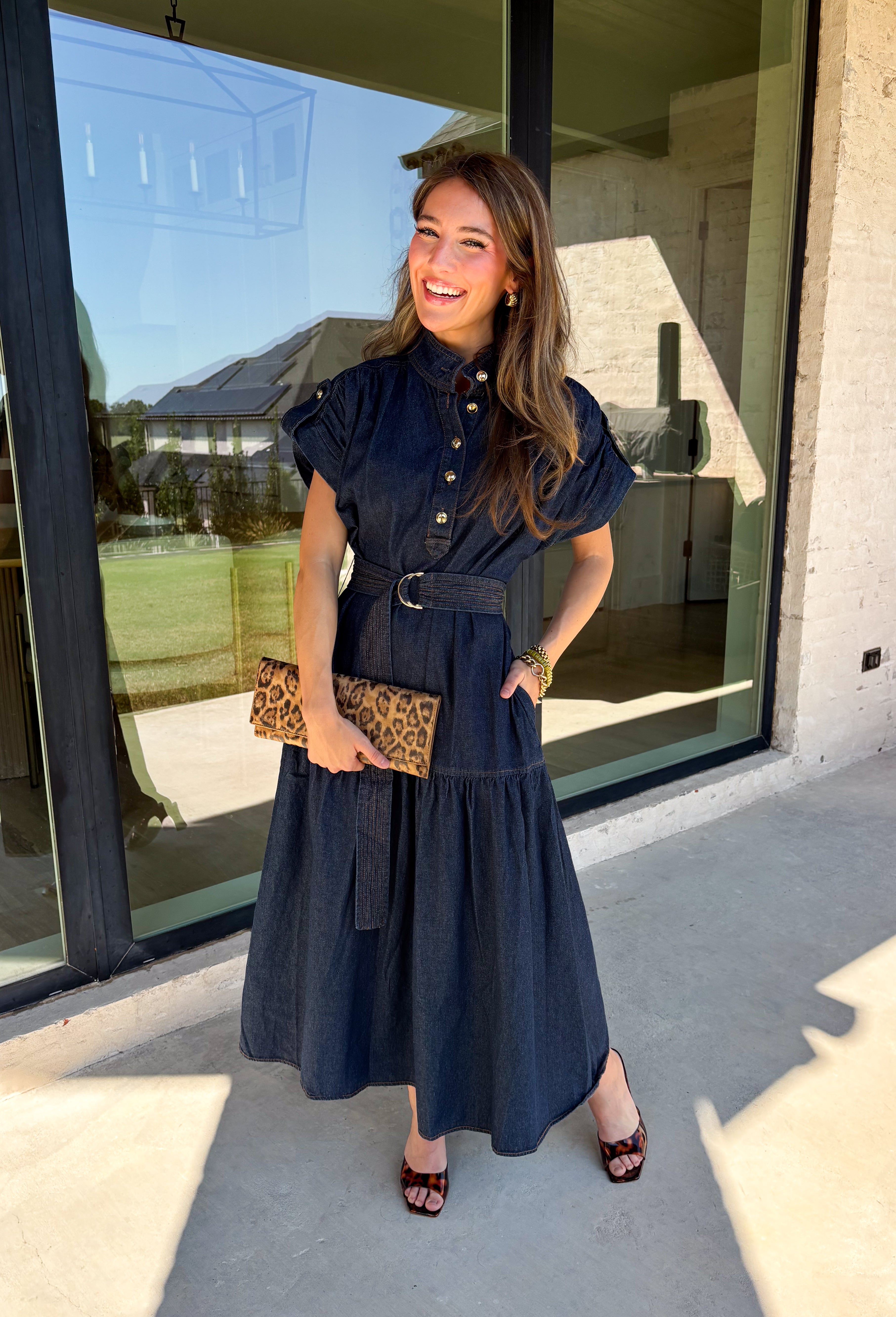 There’s something about a great denim dress that makes getting dressed feel instantly easier. This dark wash midi dress from Entro features a stand collar and partial gold button front that adds a polished touch to the classic denim look. Cap sleeves keep the silhouette easy to layer as the seasons change, while the coordinating self-tie belt lets you add definition at the waist. 