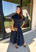 There’s something about a great denim dress that makes getting dressed feel instantly easier. This dark wash midi dress from Entro features a stand collar and partial gold button front that adds a polished touch to the classic denim look. Cap sleeves keep the silhouette easy to layer as the seasons change, while the coordinating self-tie belt lets you add definition at the waist. 