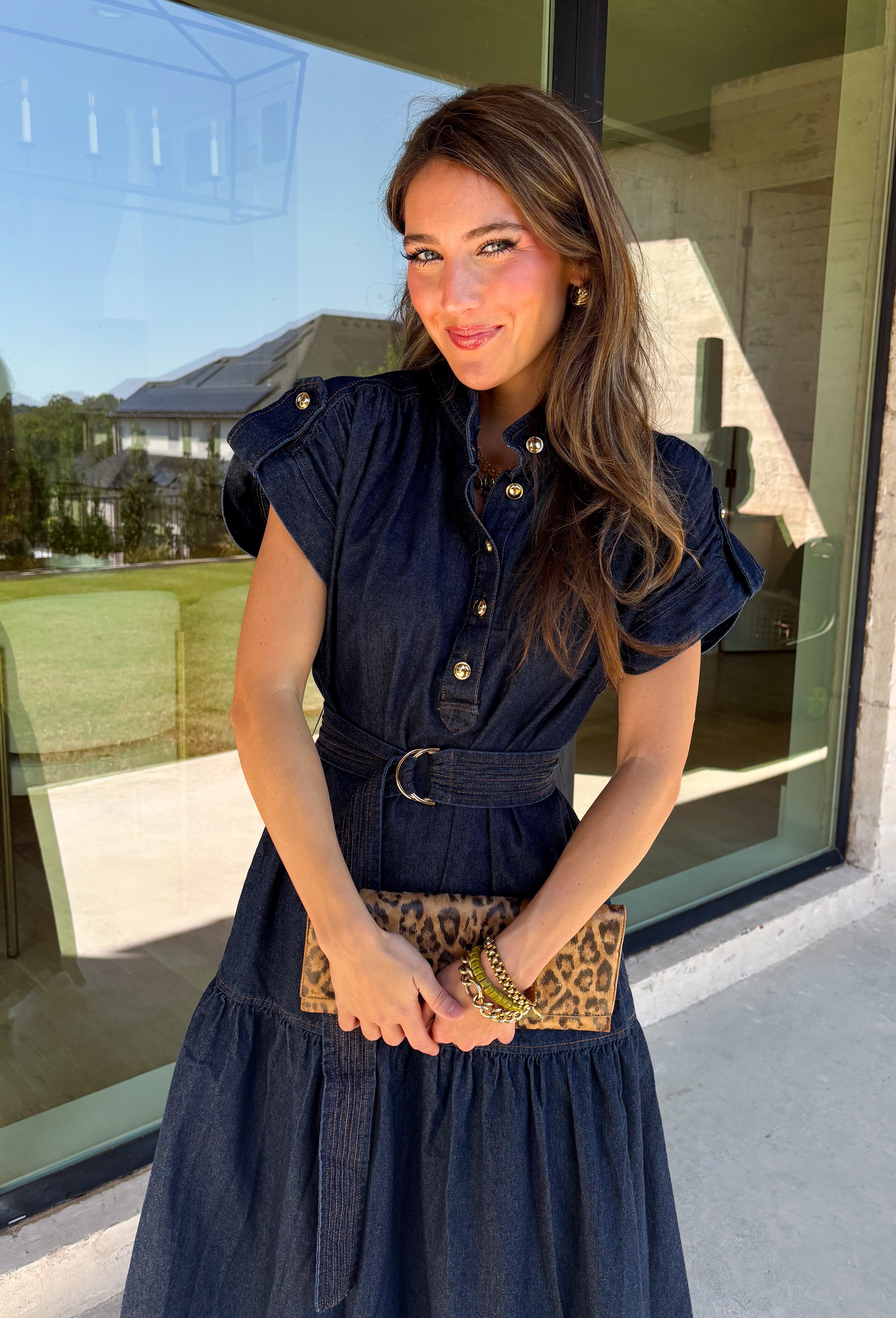 There’s something about a great denim dress that makes getting dressed feel instantly easier. This dark wash midi dress from Entro features a stand collar and partial gold button front that adds a polished touch to the classic denim look. Cap sleeves keep the silhouette easy to layer as the seasons change, while the coordinating self-tie belt lets you add definition at the waist. Finished with convenient side pockets, this versatile dress can take you from casual office days and lunch plans to football week