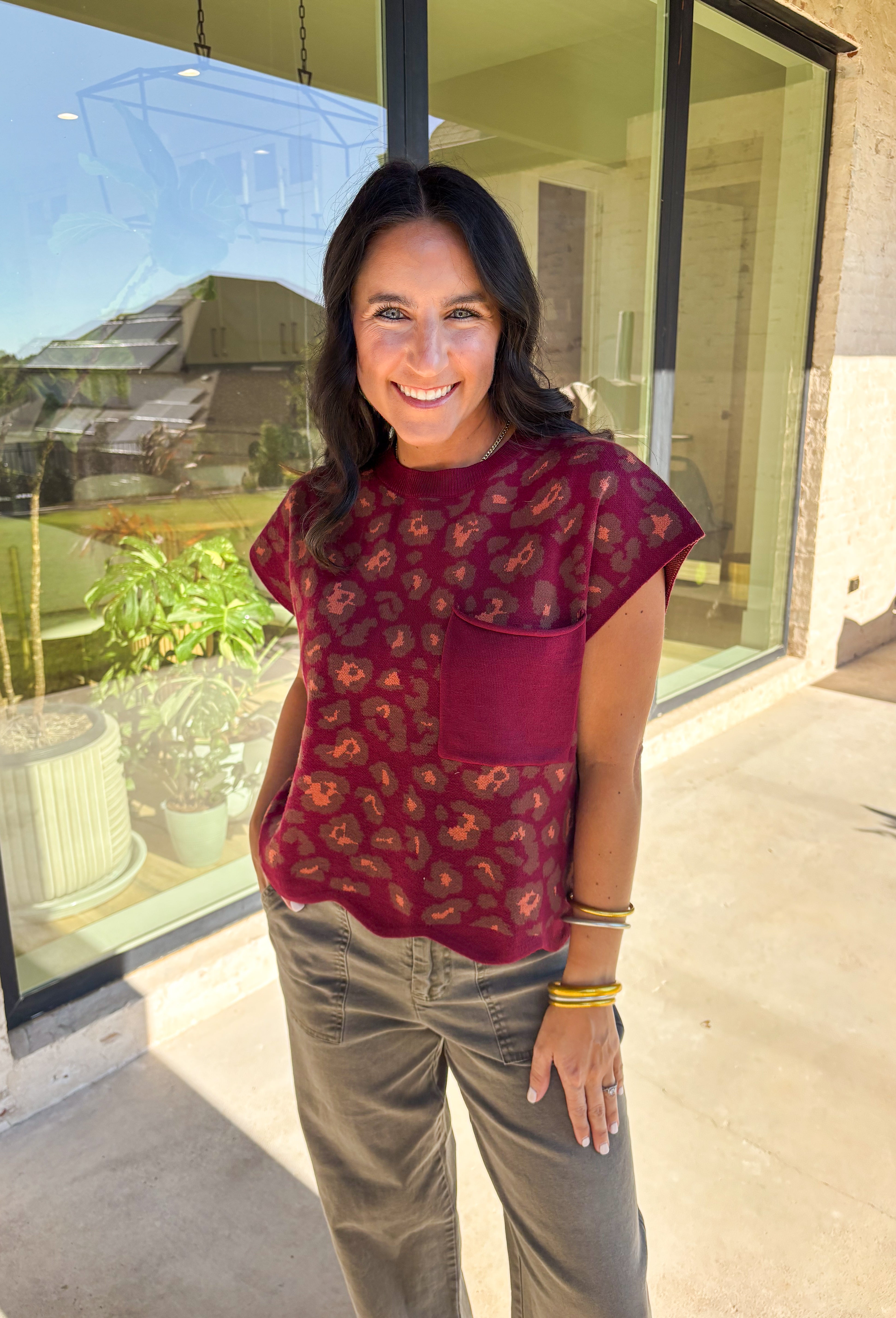This burgundy short sleeve sweater from Entro adds a touch of fun to your fall lineup. Designed with a playful leopard print and a chest patch pocket, it’s finished with a scalloped edge hem for a feminine twist. The soft knit fabric keeps it cozy yet lightweight—perfect for layering or wearing solo as the seasons shift.
