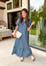 Classic stripes and feminine details make this midi dress an effortless favorite for the season. Featuring rich hunter green and soft blue stripes, this beautifully crafted cotton dress brings timeless style with a fresh autumn feel. The ruffled neckline and puff sleeves add a romantic touch, while the button-front design and flowy ruffle hem create an easy, flattering silhouette.