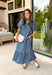 Classic stripes and feminine details make this midi dress an effortless favorite for the season. Featuring rich hunter green and soft blue stripes, this beautifully crafted cotton dress brings timeless style with a fresh autumn feel. The ruffled neckline and puff sleeves add a romantic touch, while the button-front design and flowy ruffle hem create an easy, flattering silhouette.