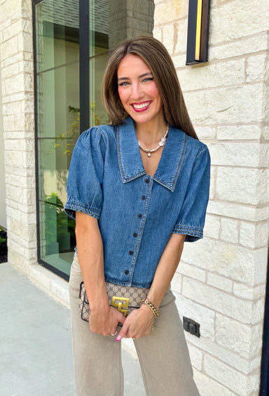 Every closet deserves a classic denim top, and this one is made to be worn on repeat! Crafted from soft medium wash denim, this timeless button-down top is an effortless staple for every season. The collared neckline gives it a polished feel, while the puff sleeves add just the right amount of feminine charm. This versatile top is one you'll reach for year after year!