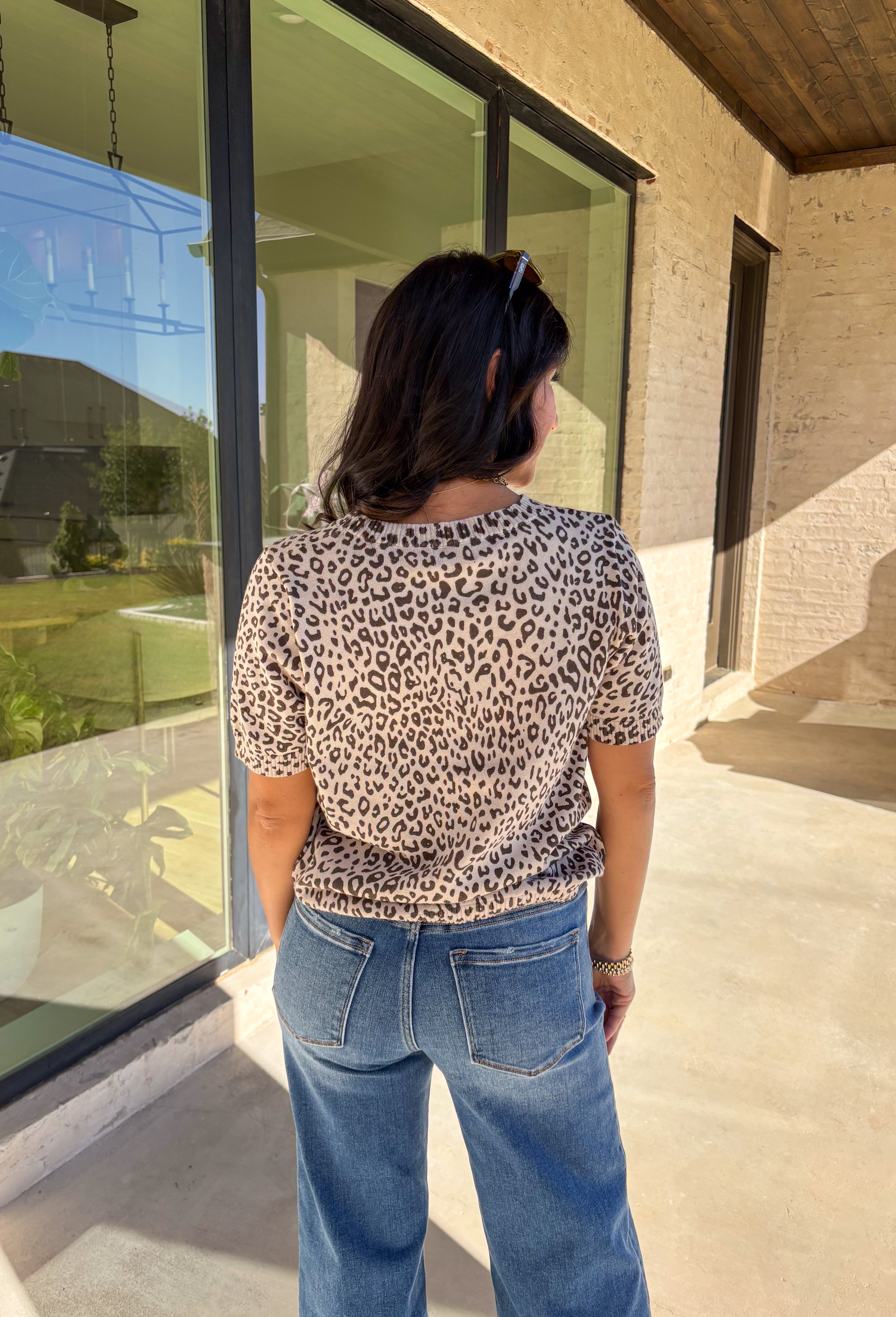 This taupe lightweight knit sweater by Fate brings effortless style to your fall wardrobe. Designed with a black leopard print, it adds a playful touch while keeping things easy and chic. The short sleeves and ribbed hem, neckline, and sleeves give it a polished finish, making it perfect for layering or wearing solo on those in-between days.