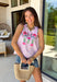 This light pink stripe tank is the sweetest mix of playful and feminine for summer! Featuring pink, red, and green floral embroidery, it adds the prettiest pop of color against the soft striped base. The scalloped hem and sleeves give it that extra delicate detail, while the side tie accents and keyhole back keep it feeling unique and thoughtfully designed. Lightweight and breathable in 100% cotton, it’s perfect for warm days when you want to feel cute and put together. 