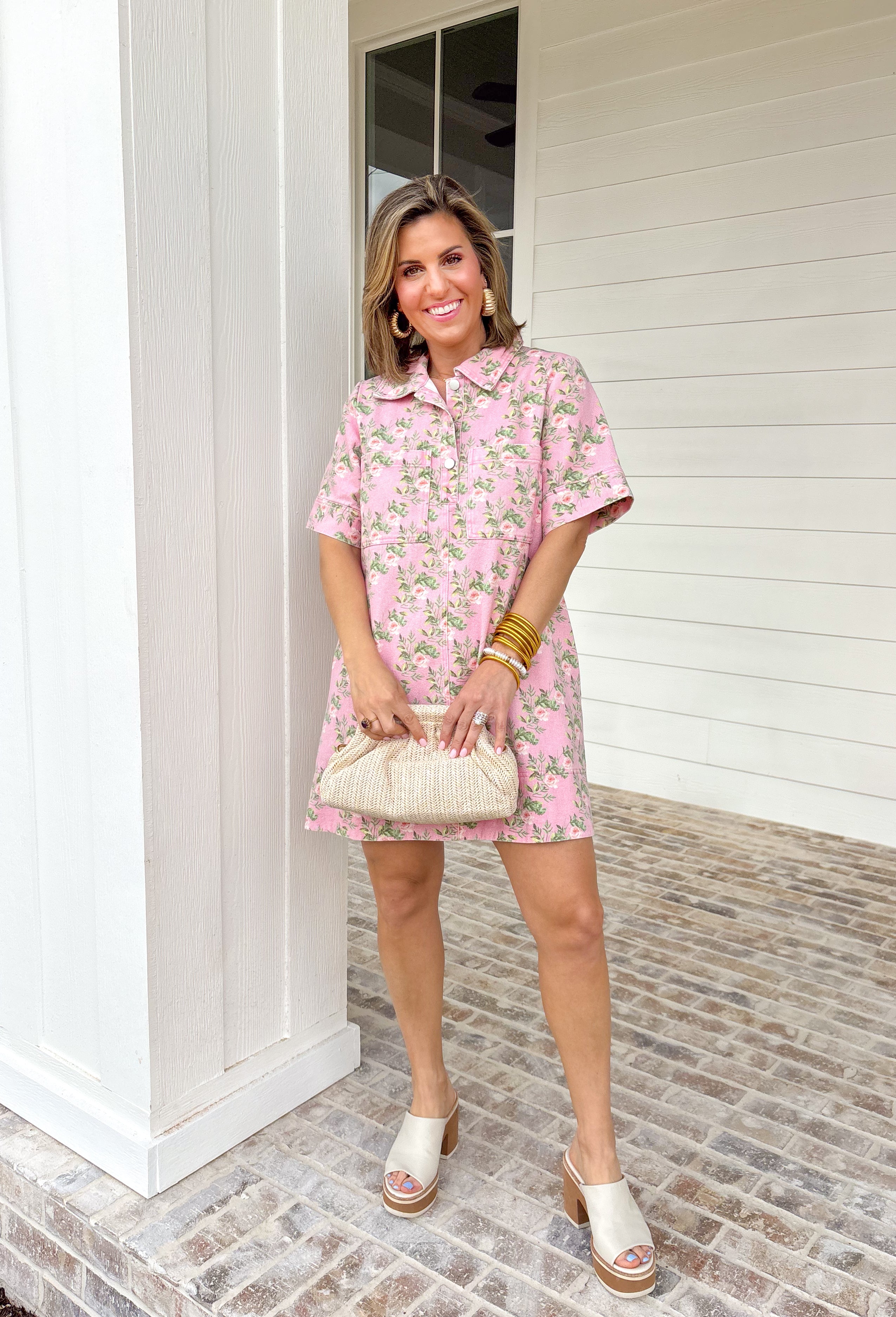Soft denim meets spring florals in this light pink short sleeve dress by Entro. Featuring a pretty floral print throughout in shades of pink and green, this dress feels fresh, cheerful, and easy to wear. The collared neckline and front button details give it a classic, polished look, while front and side pockets keep it practical for everyday wear. Made from a comfortable stretch denim, this dress is perfect for spring days when you want something cute, comfortable, and effortlessly put together.