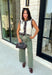 Elevate your everyday style with this timeless sweater knit that's equal parts classic and versatile. Crafted in an off-white knit with striking black and brown contrast trim, this sleeveless sweater offers a polished look you'll wear on repeat all season long. The button-front design makes it easy to style on its own or layered over a fitted long sleeve when temperatures start to cool. Whether you're heading to the office, brunch, or a weekend outing, this piece brings effortless charm to any outfit.