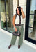 Elevate your everyday style with this timeless sweater knit that's equal parts classic and versatile. Crafted in an off-white knit with striking black and brown contrast trim, this sleeveless sweater offers a polished look you'll wear on repeat all season long. The button-front design makes it easy to style on its own or layered over a fitted long sleeve when temperatures start to cool. Whether you're heading to the office, brunch, or a weekend outing, this piece brings effortless charm to any outfit.