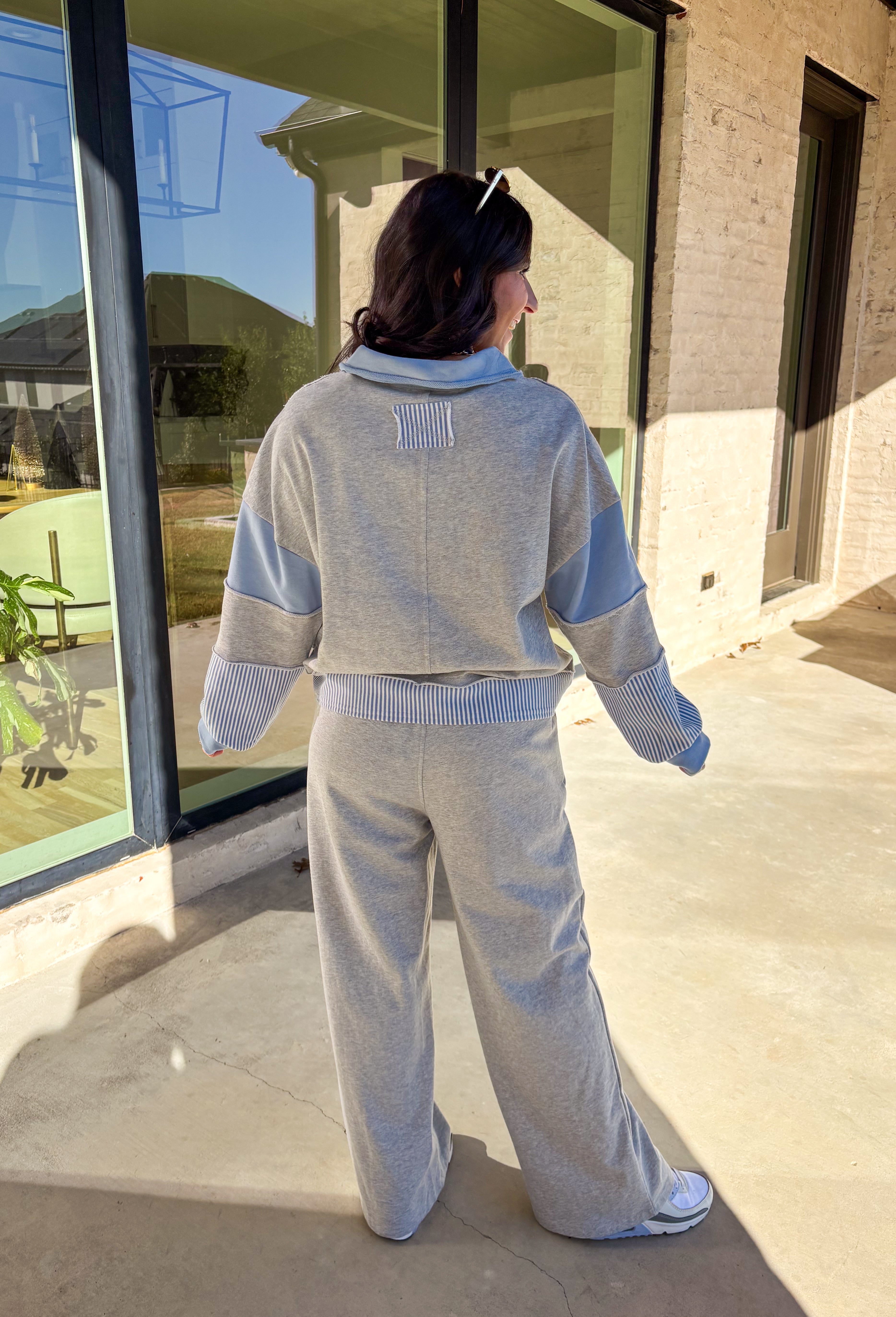 Effortless style meets everyday comfort in this lightweight two-piece set by New In. The heather gray long sleeve top features sporty blue and off-white stripe detailing along the front, sleeves, and hem for a fresh pop of color. The matching wide leg pants tie it all together with a coordinating blue waistband and drawstring. Wear them as a matching set for a put-together look or mix and match for laid-back spring days.