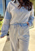 Effortless style meets everyday comfort in this lightweight two-piece set by New In. The heather gray long sleeve top features sporty blue and off-white stripe detailing along the front, sleeves, and hem for a fresh pop of color. The matching wide leg pants tie it all together with a coordinating blue waistband and drawstring. Wear them as a matching set for a put-together look or mix and match for laid-back spring days.