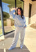 Effortless style meets everyday comfort in this lightweight two-piece set by New In. The heather gray long sleeve top features sporty blue and off-white stripe detailing along the front, sleeves, and hem for a fresh pop of color. The matching wide leg pants tie it all together with a coordinating blue waistband and drawstring. Wear them as a matching set for a put-together look or mix and match for laid-back spring days.