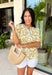This neutral floral top is such a bright and easy pick for summer days! The soft yellow floral print with subtle pops of green gives it that fresh, feel-good look that’s perfect for the season. The smocked elastic waist creates a flattering shape while still keeping things comfortable and easy to wear. Finished with a v-neckline, it has that effortless, feminine feel you’ll reach for again and again. Lightweight and breathable in cotton, it’s perfect for everything from errands to lunch plans. 