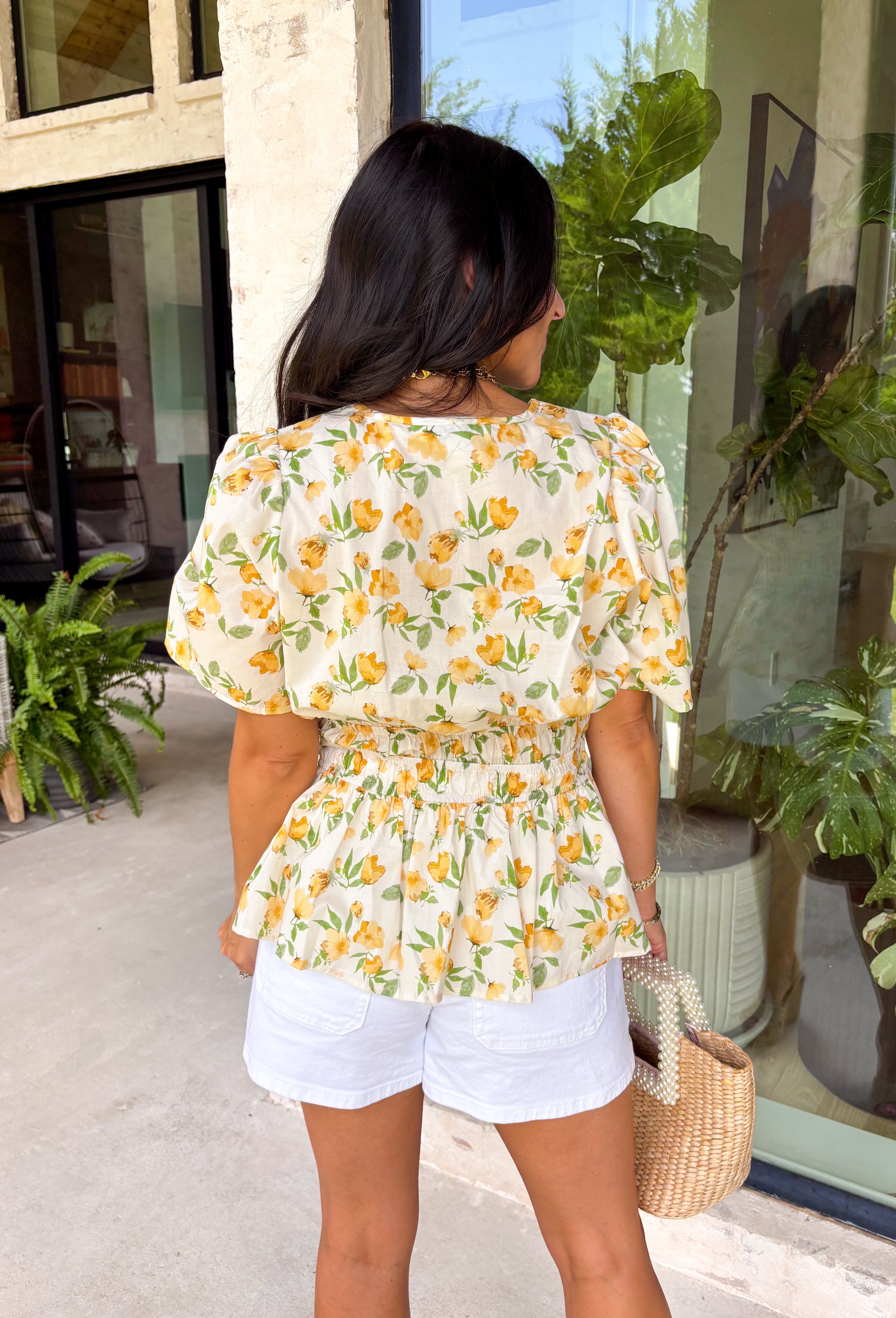This neutral floral top is such a bright and easy pick for summer days! The soft yellow floral print with subtle pops of green gives it that fresh, feel-good look that’s perfect for the season. The smocked elastic waist creates a flattering shape while still keeping things comfortable and easy to wear. Finished with a v-neckline, it has that effortless, feminine feel you’ll reach for again and again. Lightweight and breathable in cotton, it’s perfect for everything from errands to lunch plans. 