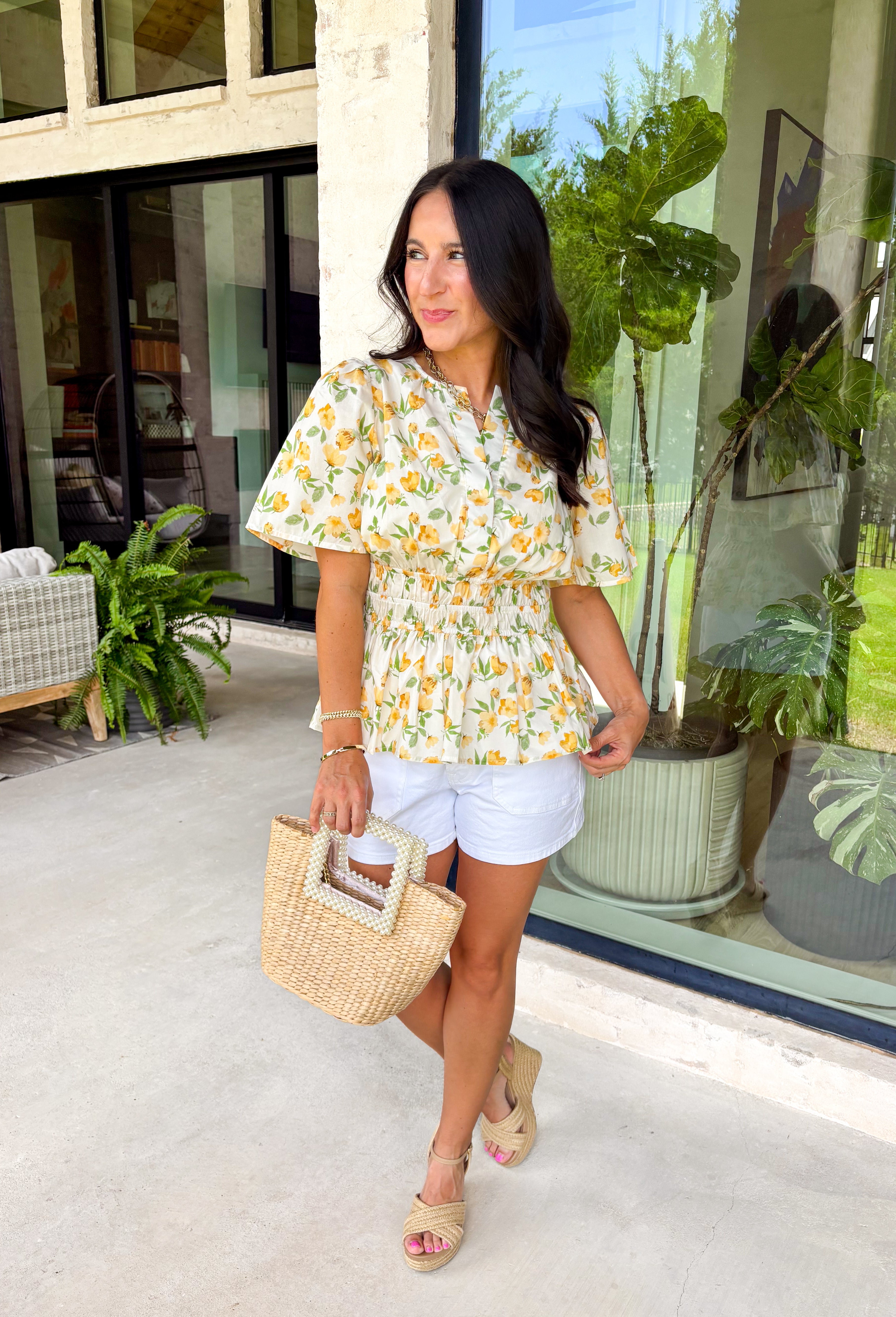 This neutral floral top is such a bright and easy pick for summer days! The soft yellow floral print with subtle pops of green gives it that fresh, feel-good look that’s perfect for the season. The smocked elastic waist creates a flattering shape while still keeping things comfortable and easy to wear. Finished with a v-neckline, it has that effortless, feminine feel you’ll reach for again and again. Lightweight and breathable in cotton, it’s perfect for everything from errands to lunch plans. 