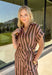 Warm neutral stripes make this Entro top an easy addition to your fall lineup. The button-front design gives it a classic feel, while the self-tie waist adds shape and a playful finishing touch. Short sleeves keep it lightweight enough for those warmer autumn days, making it an easy option for work, lunch plans, or a weekend out. Pair it with the matching pants for a coordinated two-piece set that does all the styling for you, or wear it individually with denim or solid bottoms for even more outfit options.